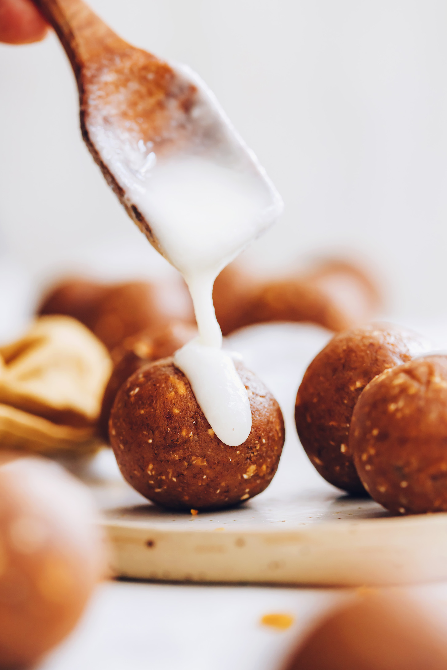 Drizzling melted coconut butter over pumpkin spice cake bites
