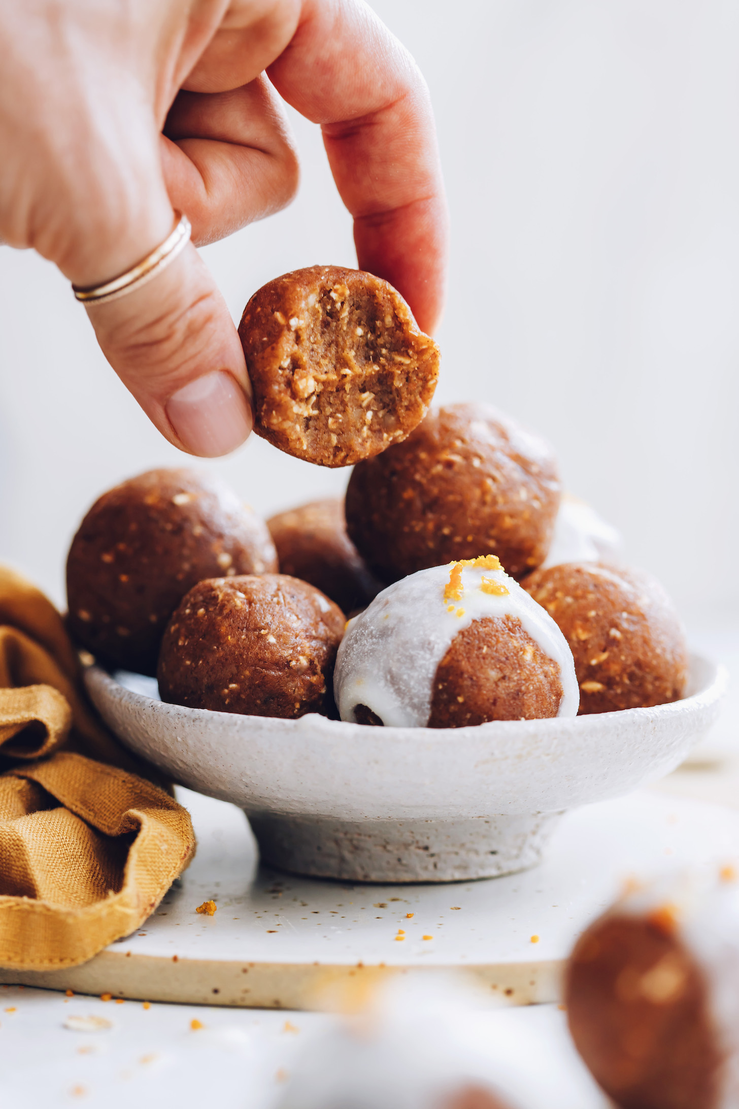 Picking up a pumpkin spice cake bite from a bowl