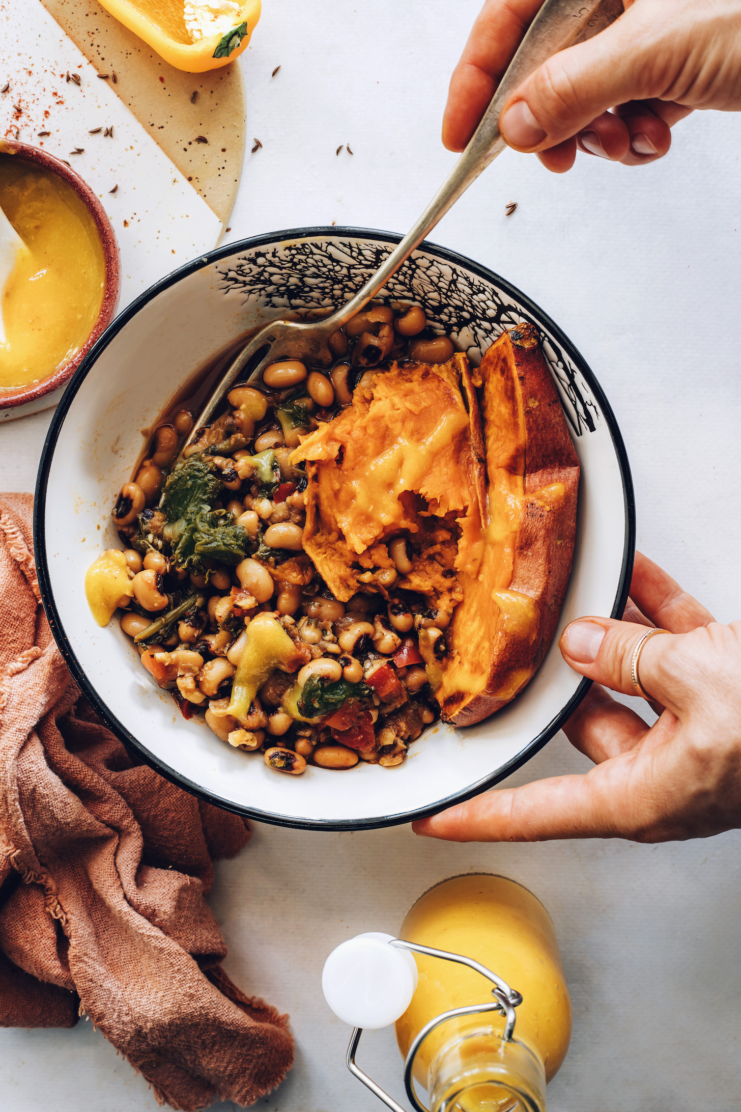Holding a fork in a black eyed pea nourish bowl