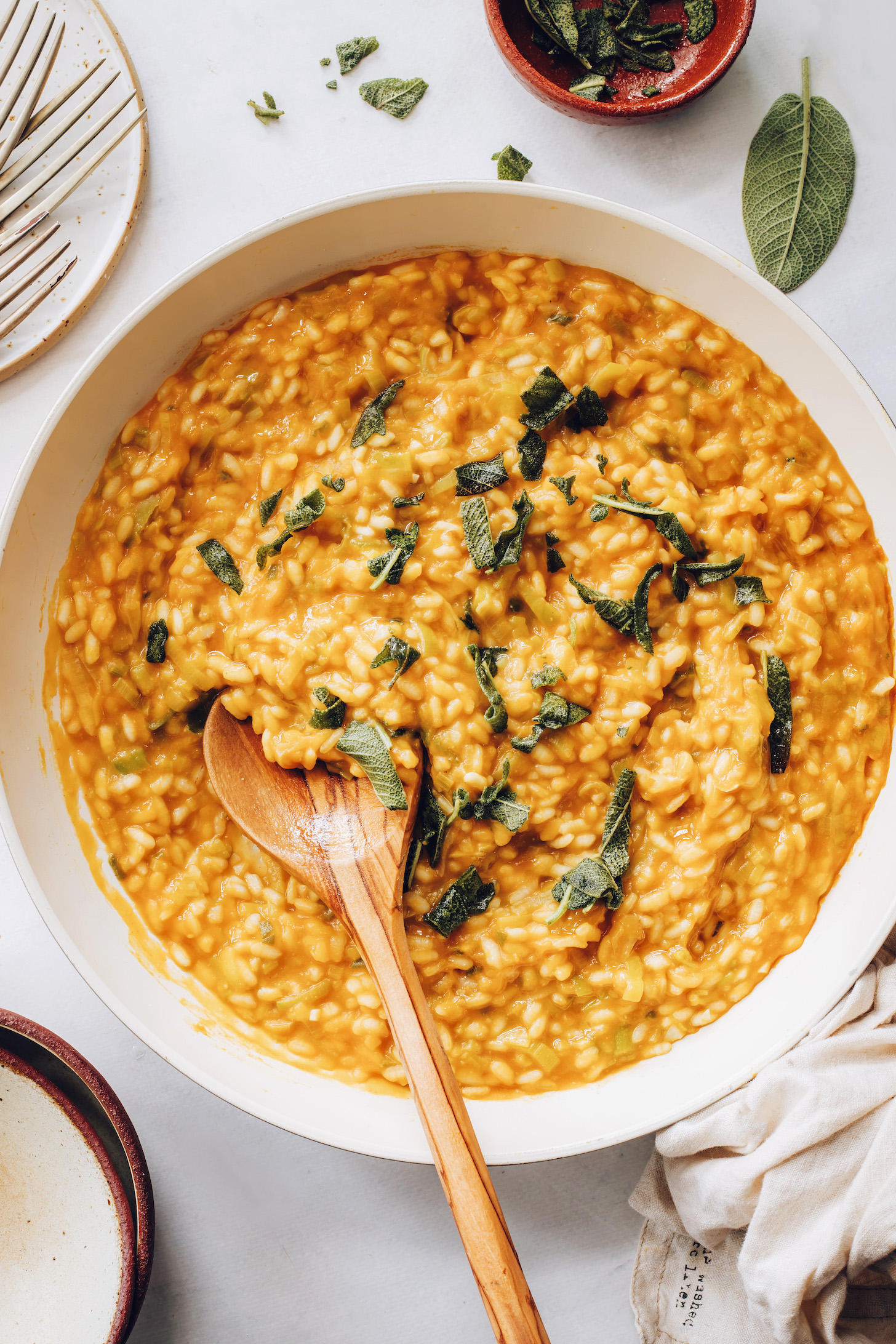 Large pan of pumpkin risotto with crispy sage
