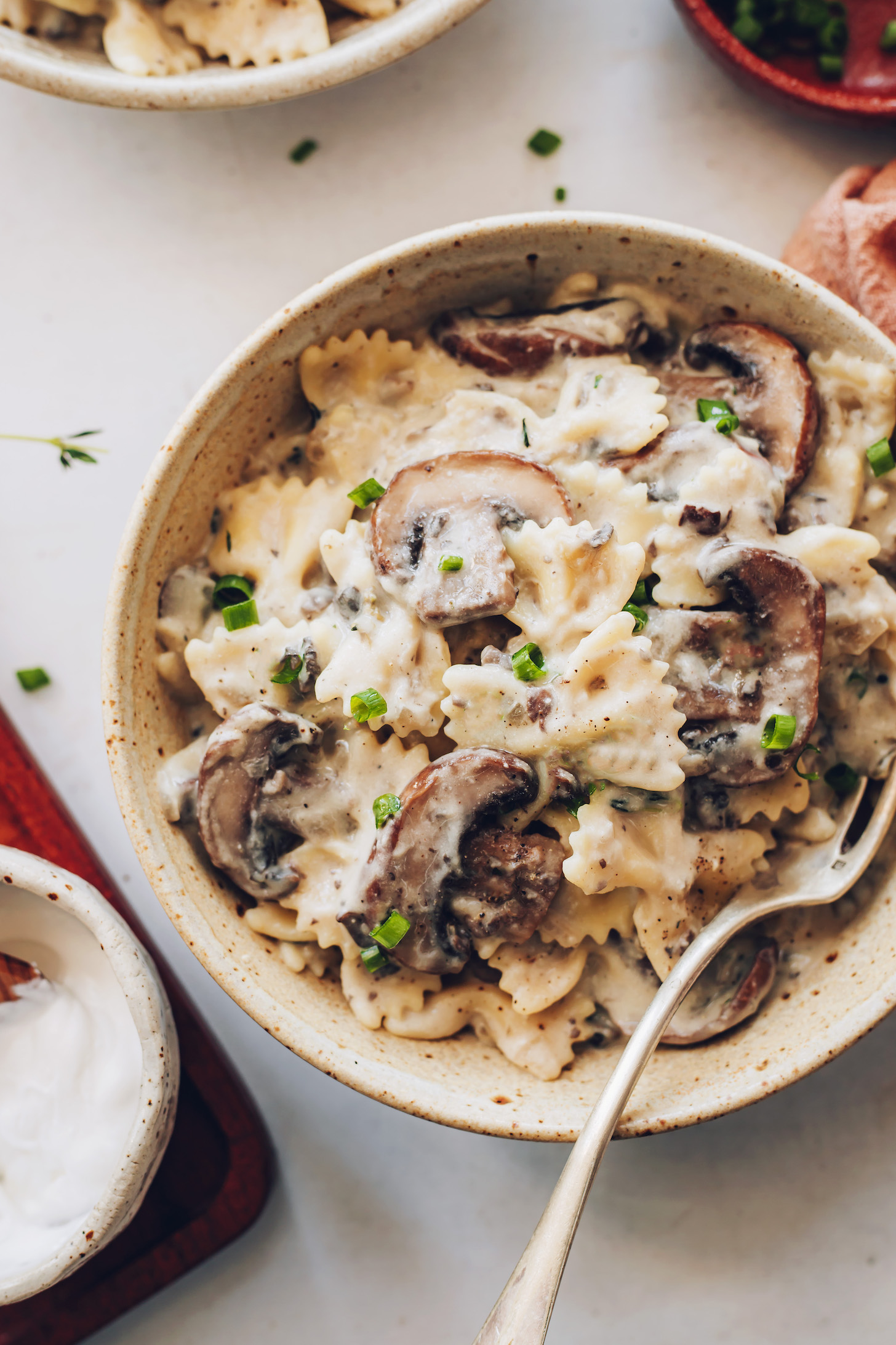 Bowl of vegan mushroom stroganoff topped with chives
