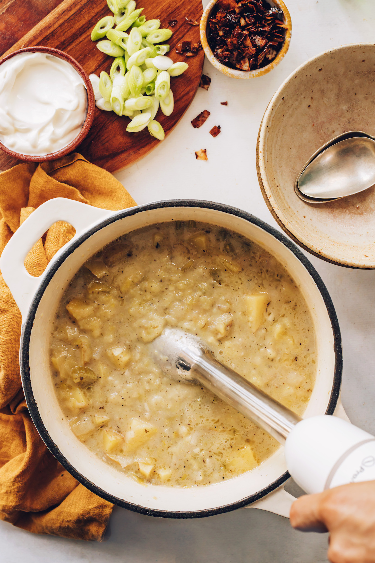 Using an immersion blender to purée potato leek soup