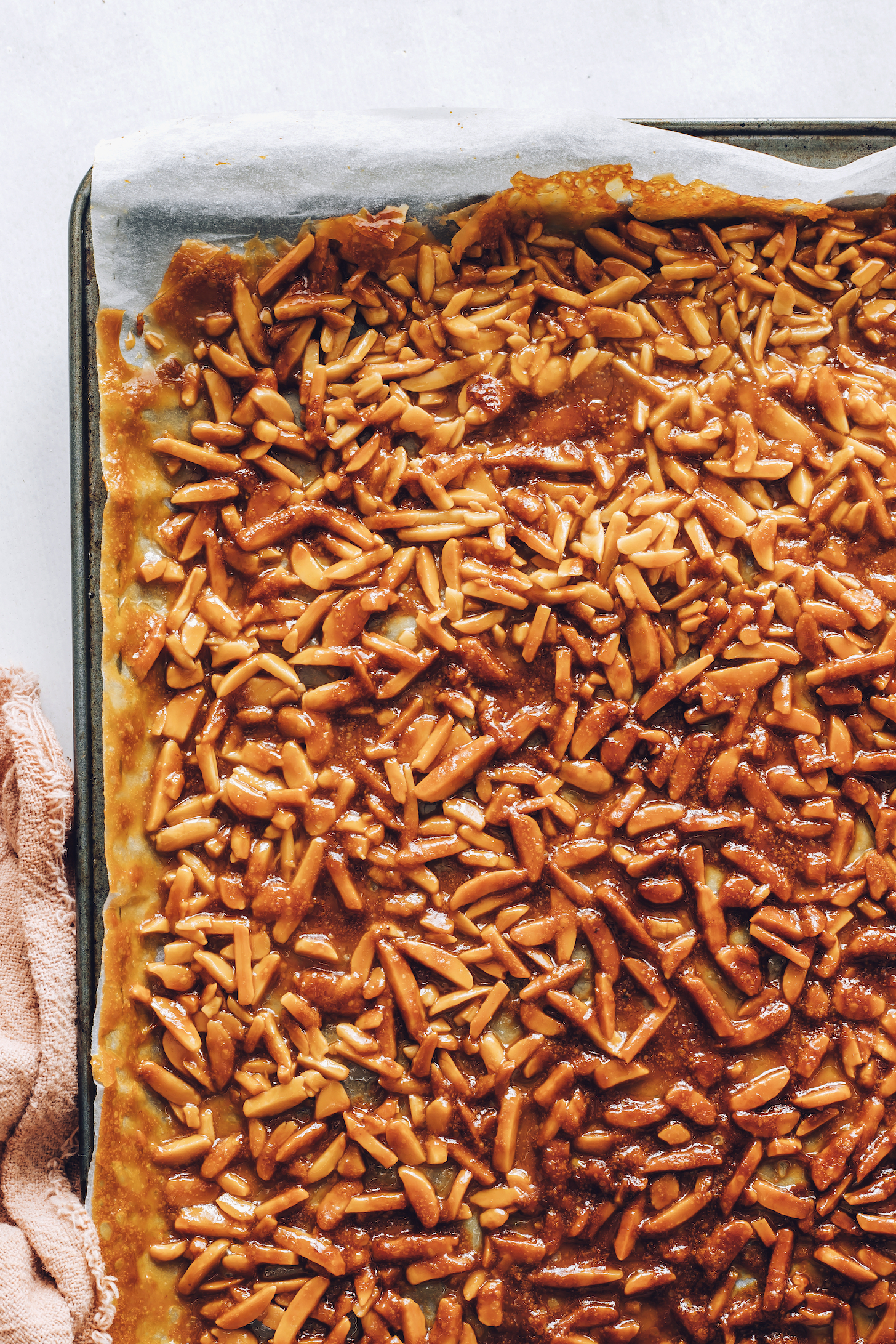 Baked almond brittle on a baking sheet