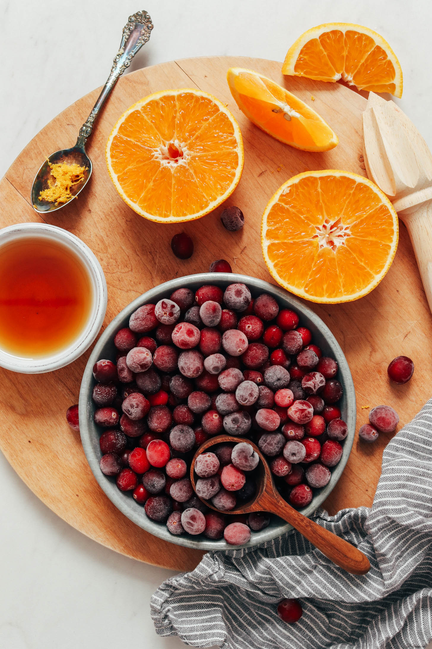 Sliced oranges, orange zest, maple syrup, and unsweetened cranberries