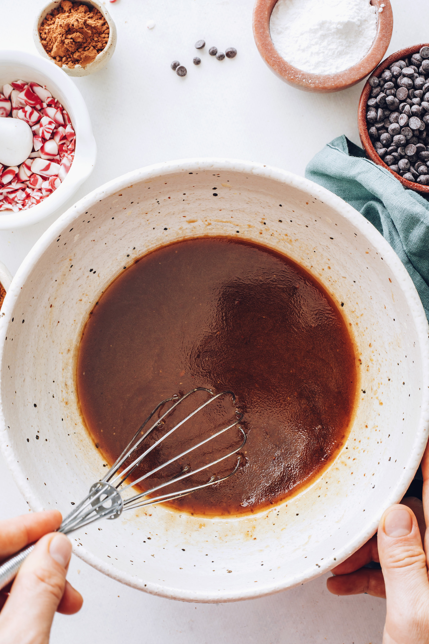 Stirring flax eggs, coconut oil, coconut sugar, vanilla, and peppermint extract