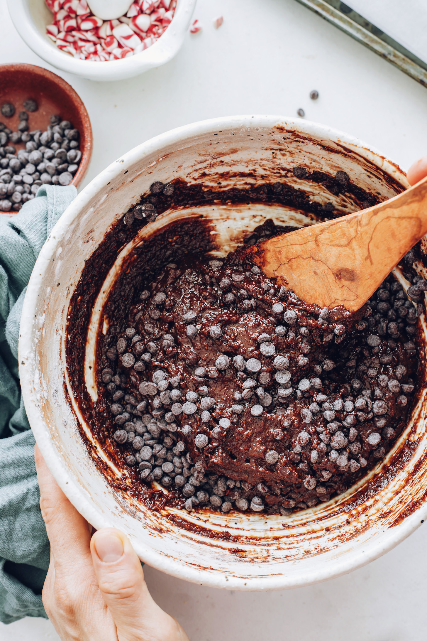 Stirring chocolate chips into fudgy chocolate cookie batter