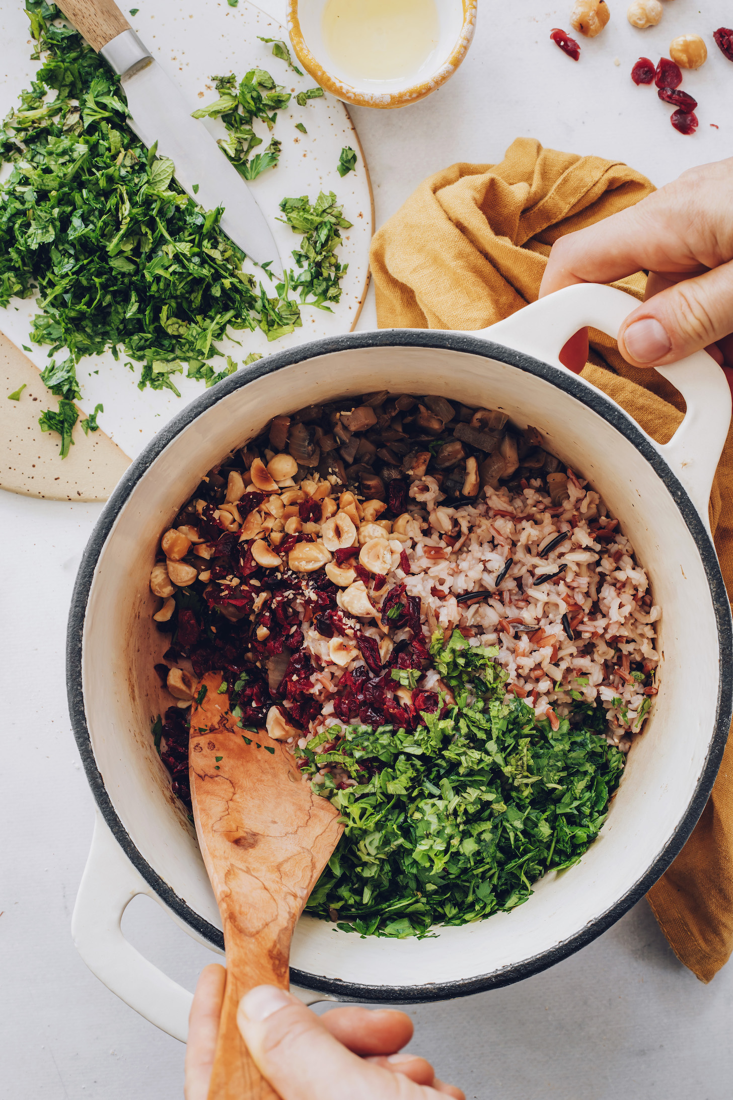 Pot of sautéed mushrooms and onions, wild rice blend, fresh herbs, cranberries, and hazelnuts