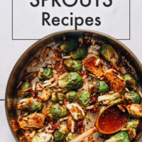 Pan of roasted Brussels sprouts with a wooden spoon in it