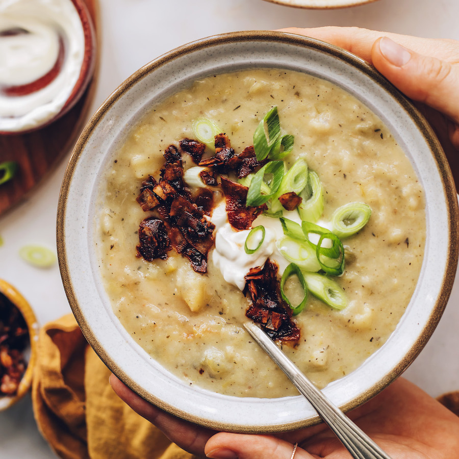 Holding a bowl of vegan potato leek soup