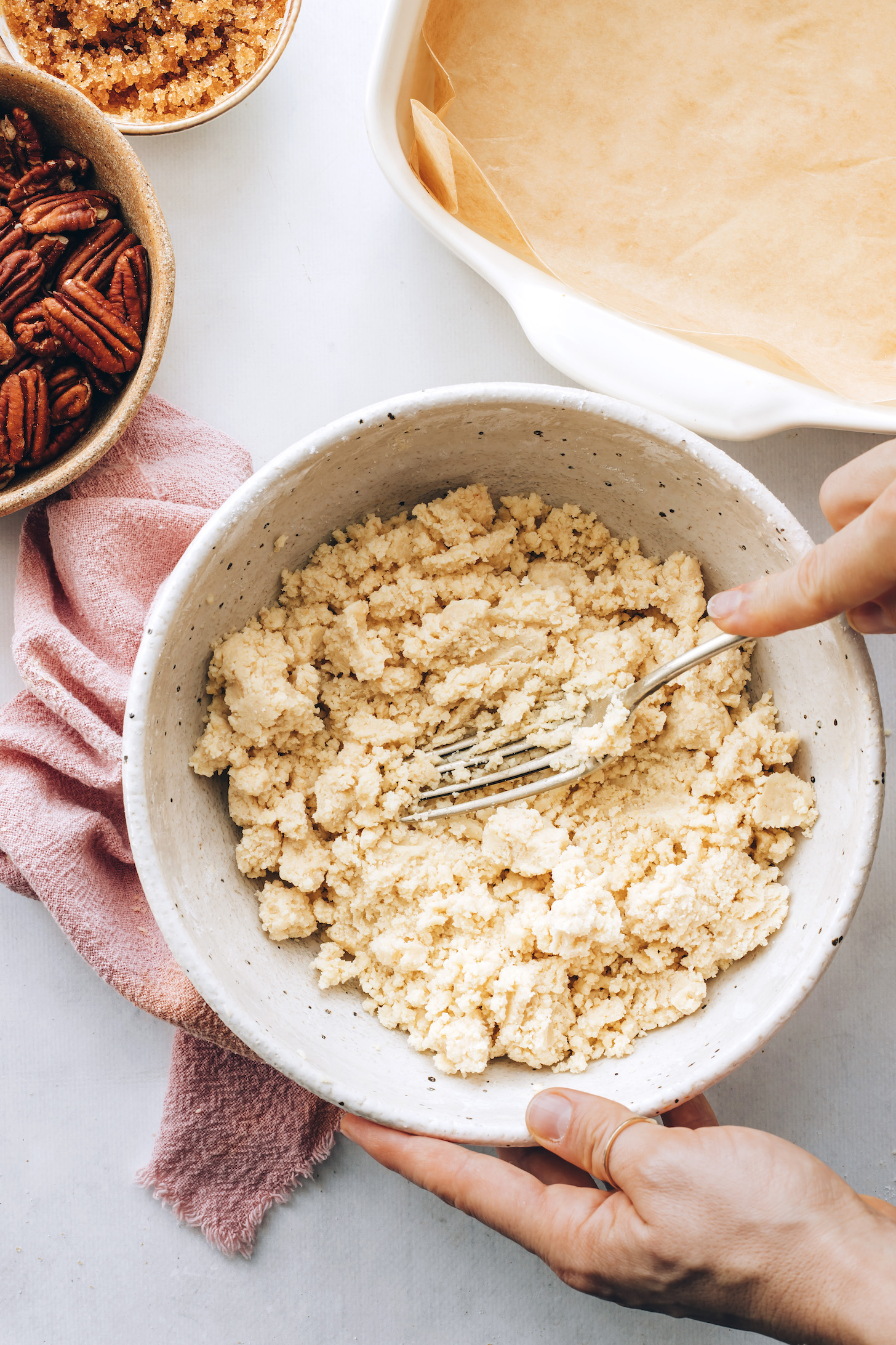 Using a fork to mix the shortbread crust ingredients