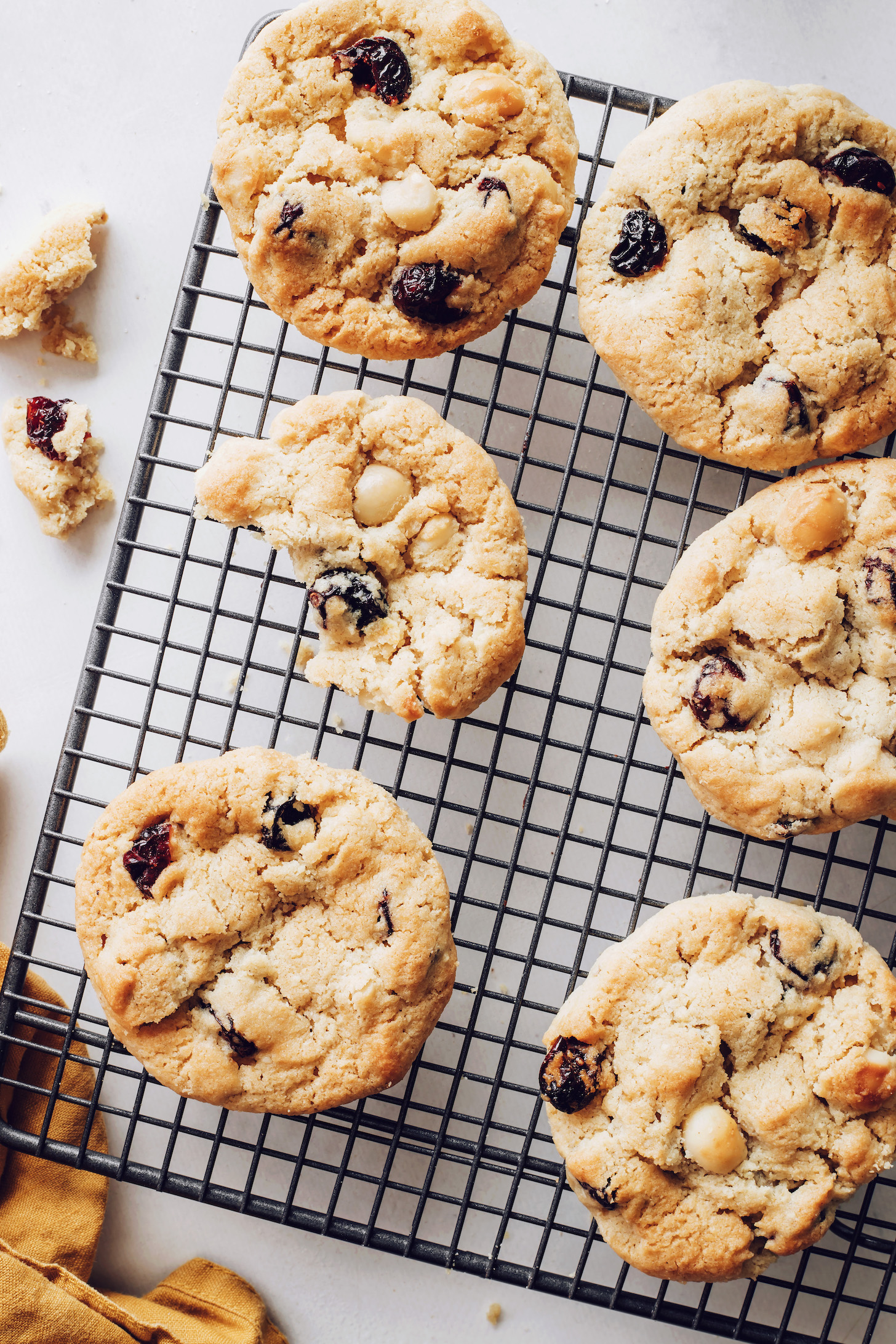 Cranberry macadamia nut cookies on a cooling rack