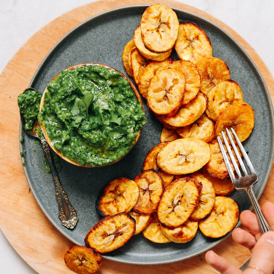 Using a fork to pick up a slice of roasted plantain