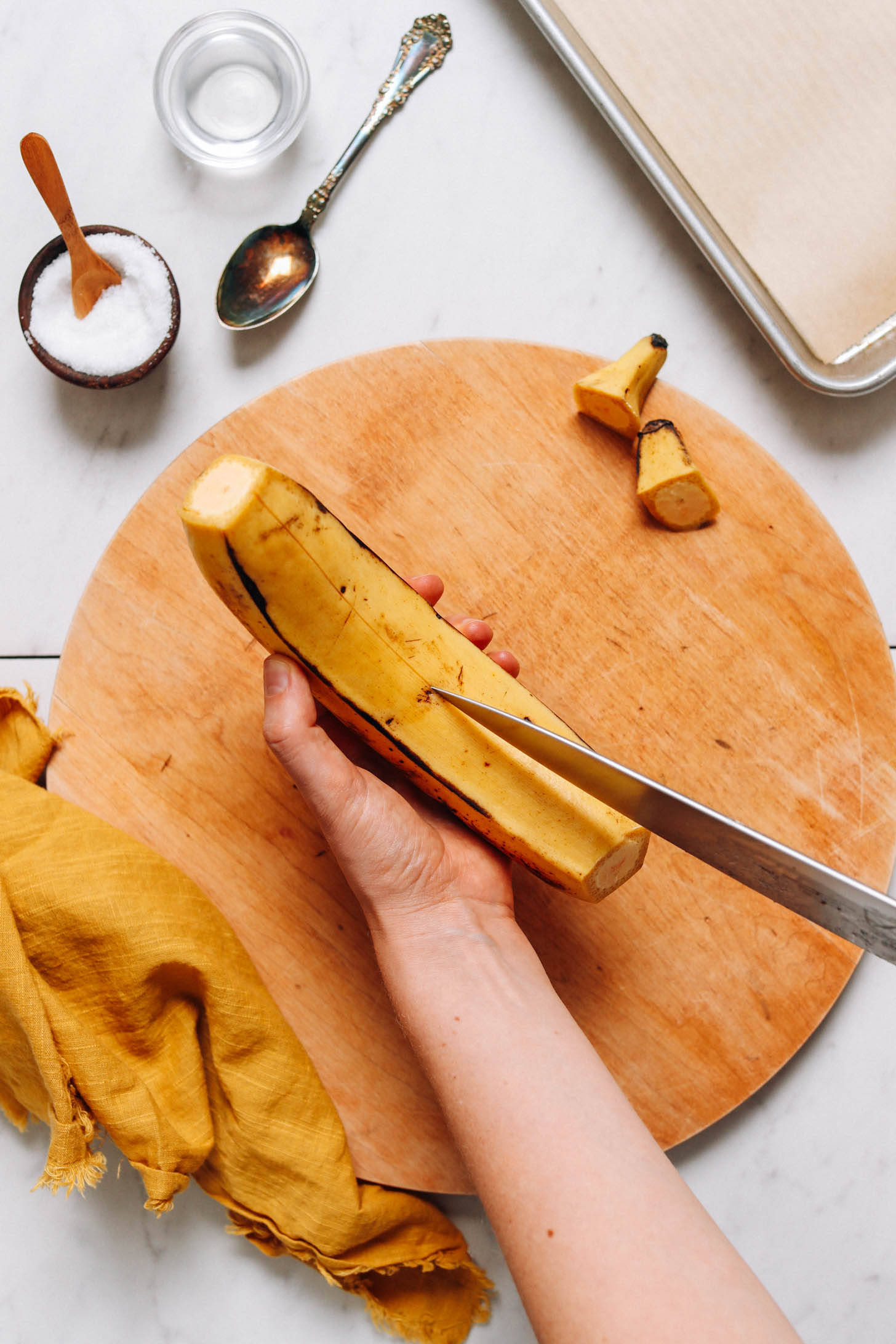 Cutting the peel off of a plantain