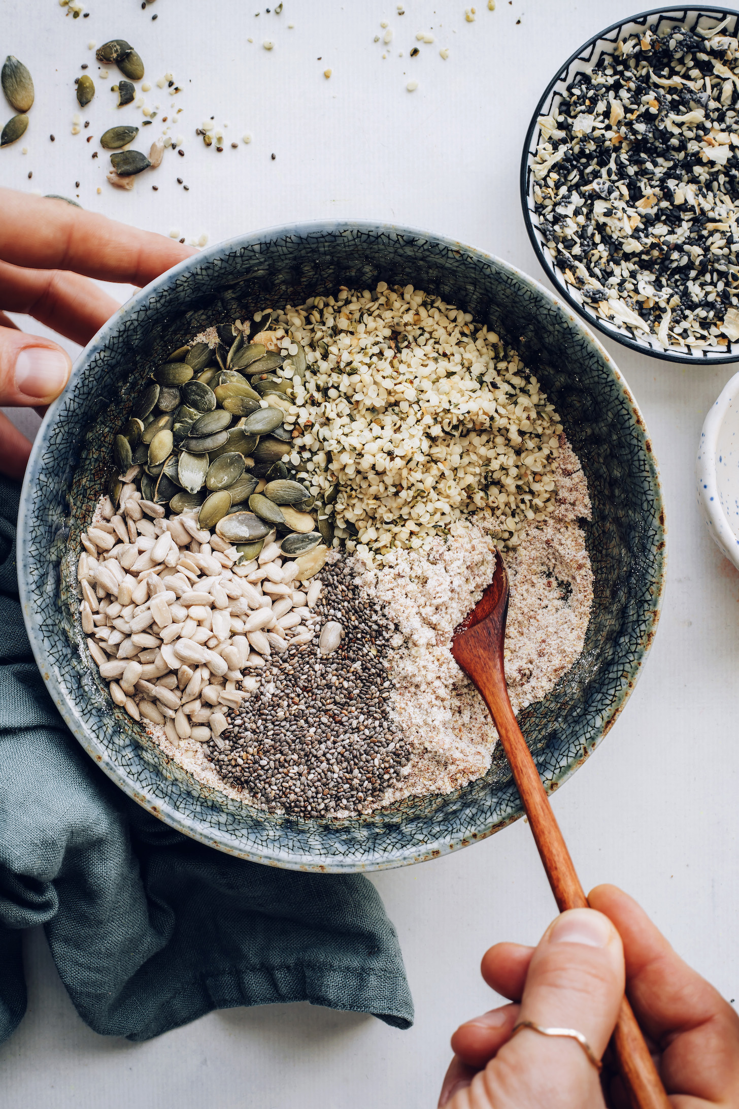 Stirring brown rice flour, seeds, and salt in a bowl