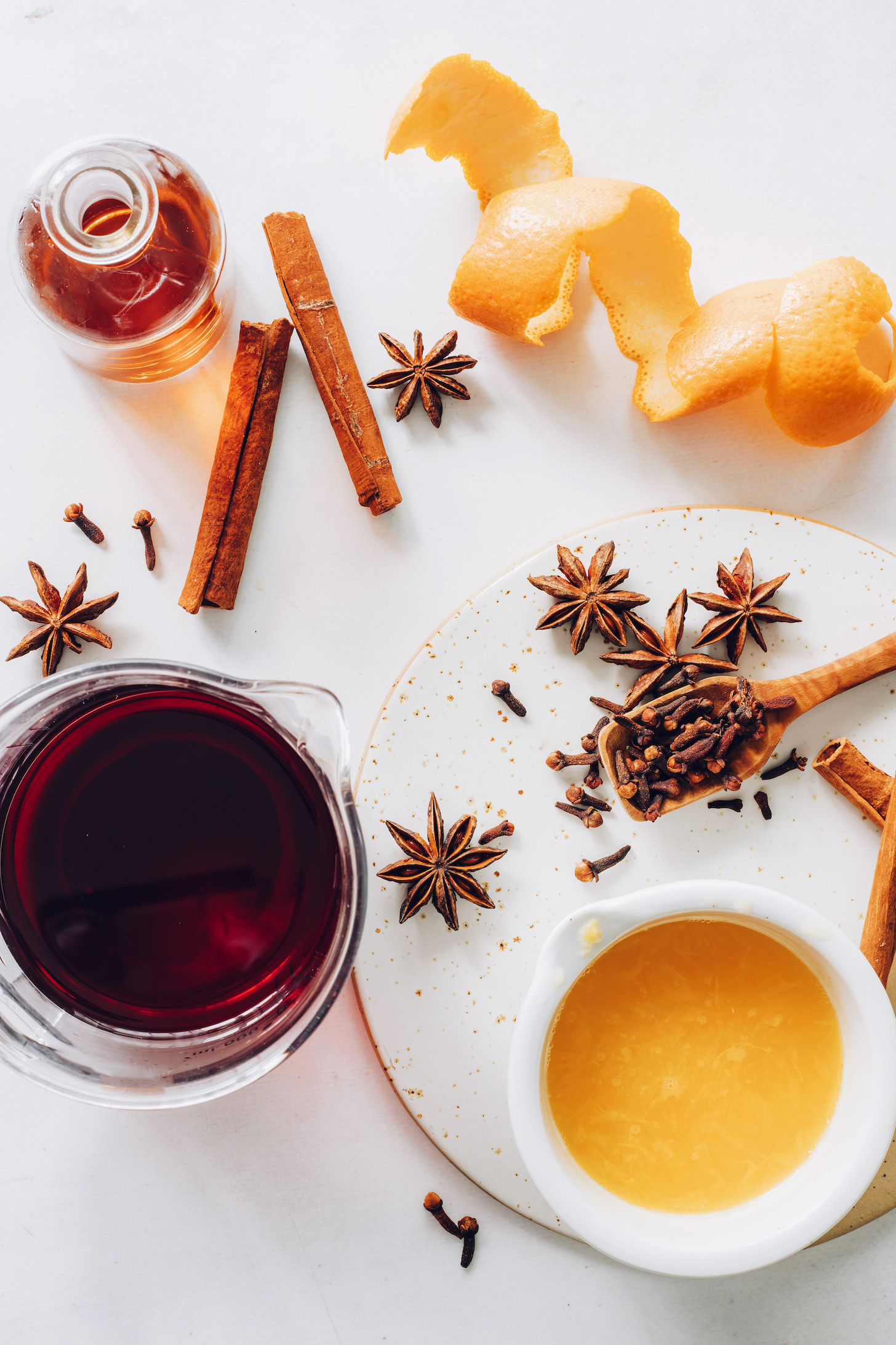 Cinnamon sticks, star anise, cloves, orange peel, orange juice, tart cherry juice, and whiskey