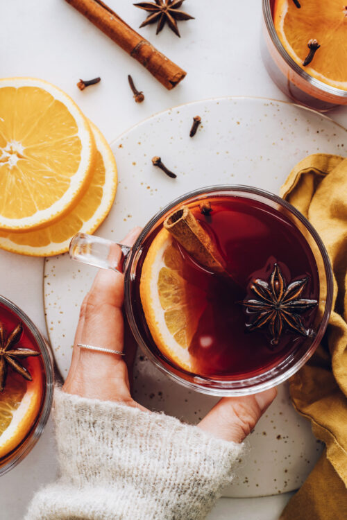 Hands holding a mug of non alcoholic mulled "wine"