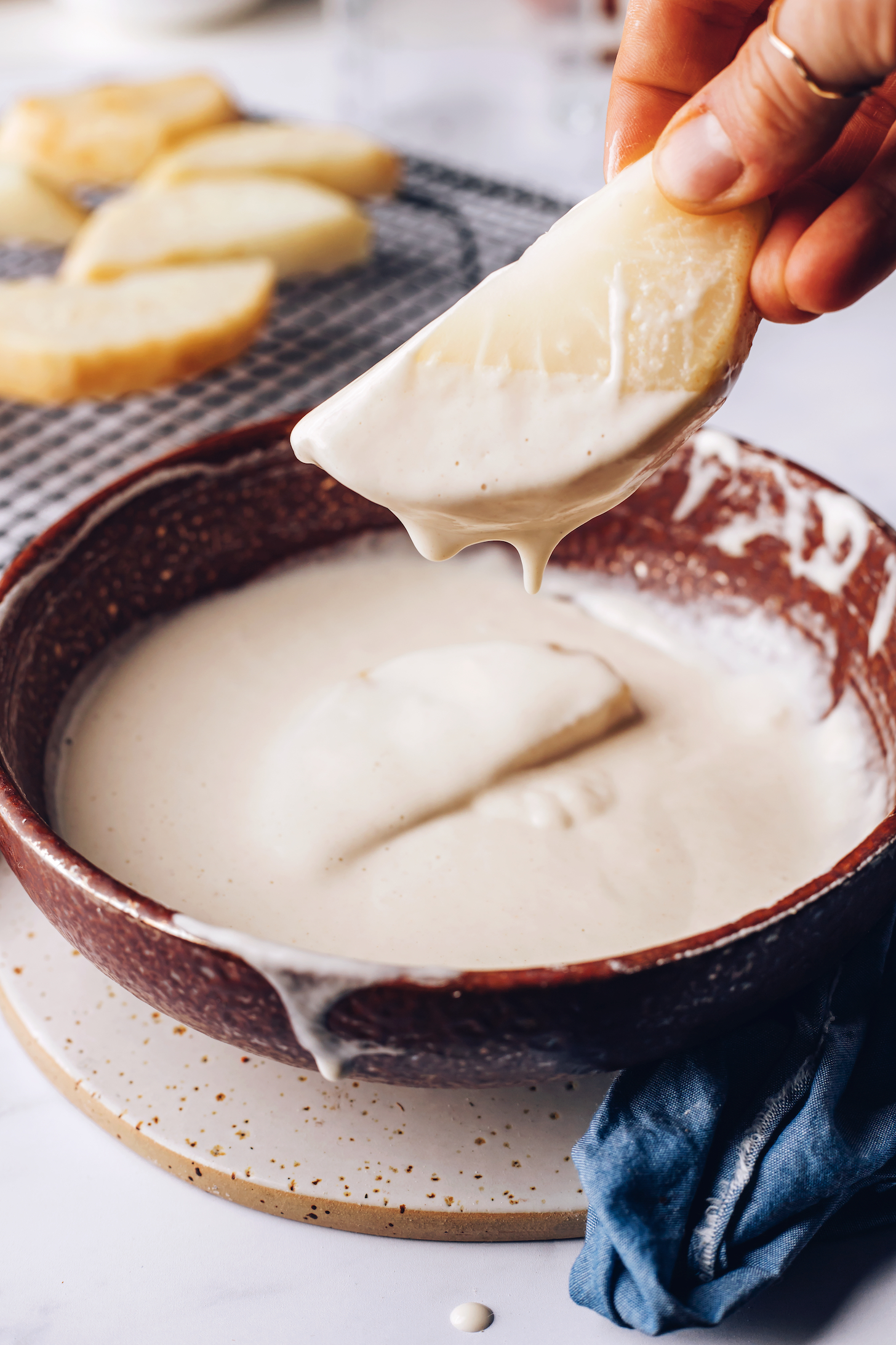Dipping boiled celeriac into a gluten-free batter