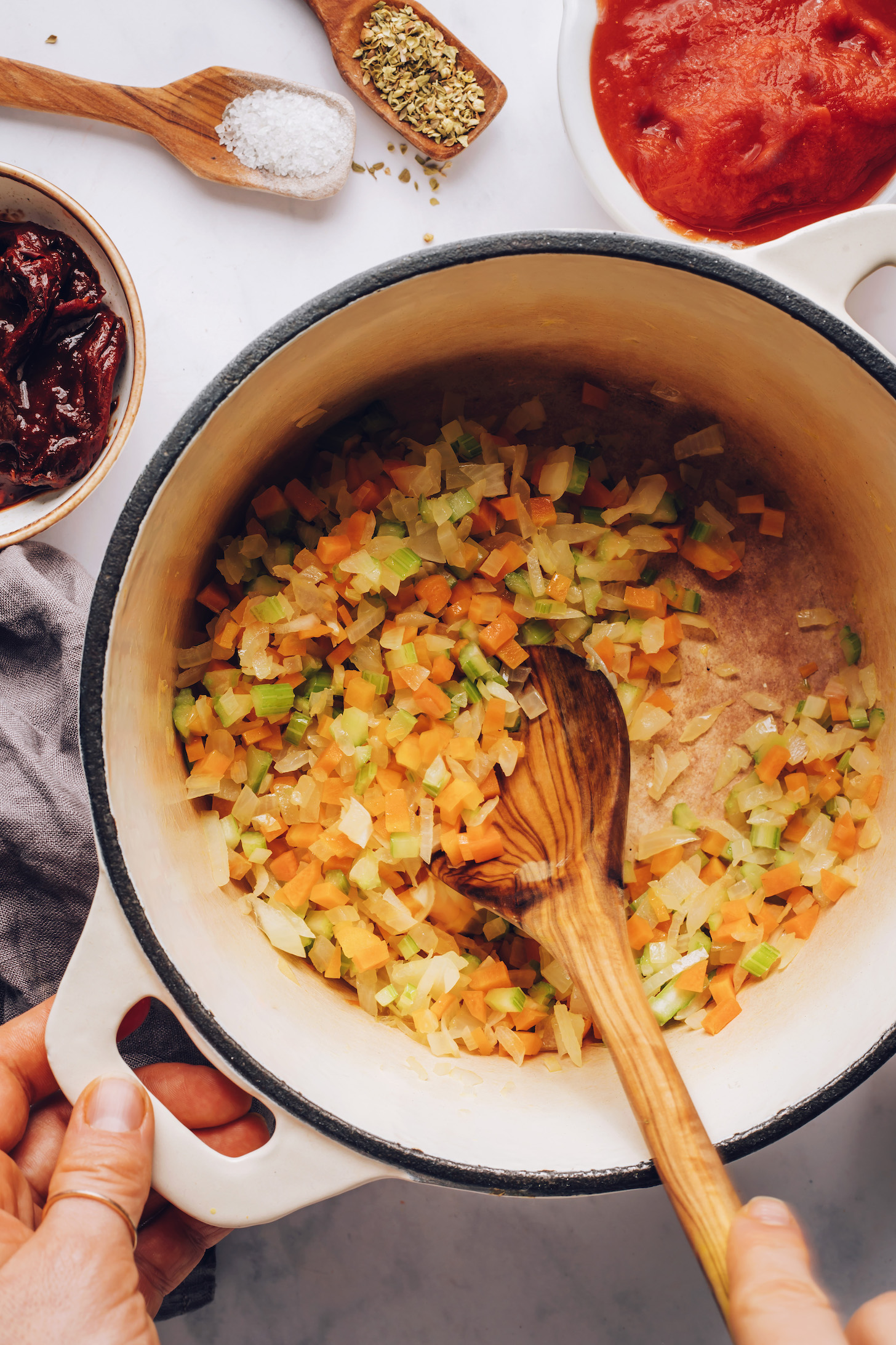 Sautéing onion, garlic, carrots, and celery in a Dutch oven