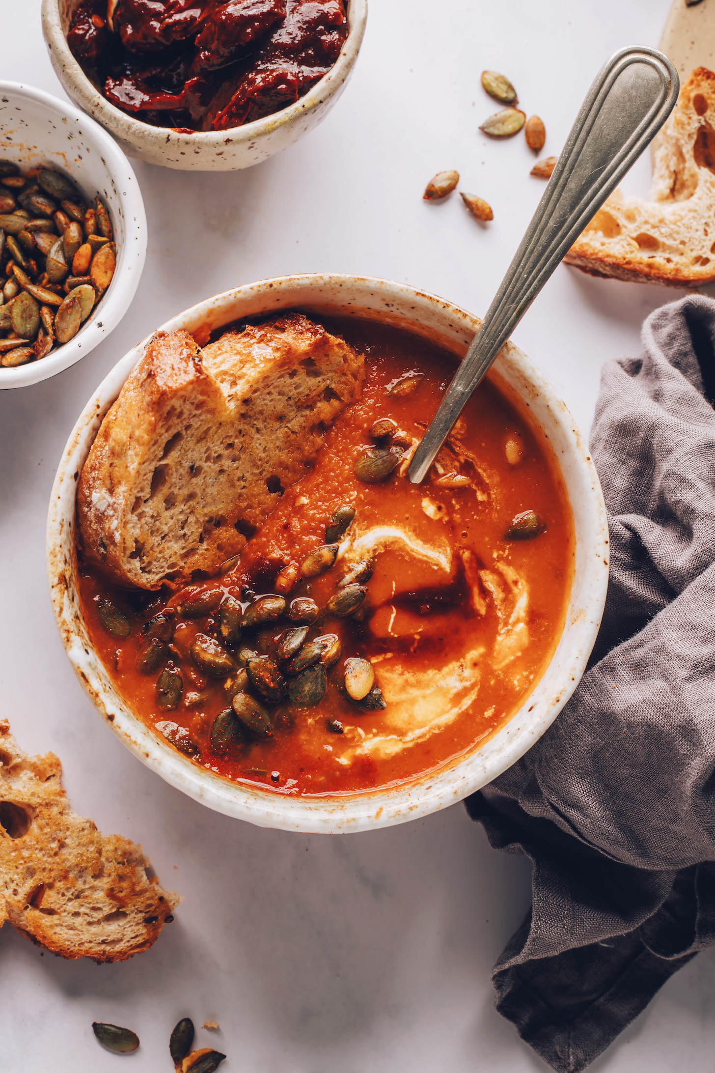 Spoon submerged in a bowl of spicy tomato soup