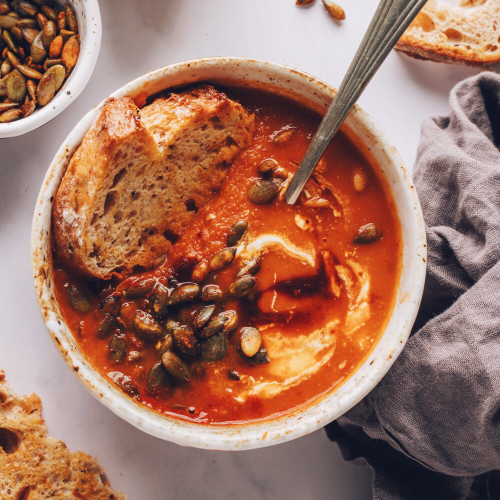 Slice of bread in a bowl of creamy chipotle tomato soup