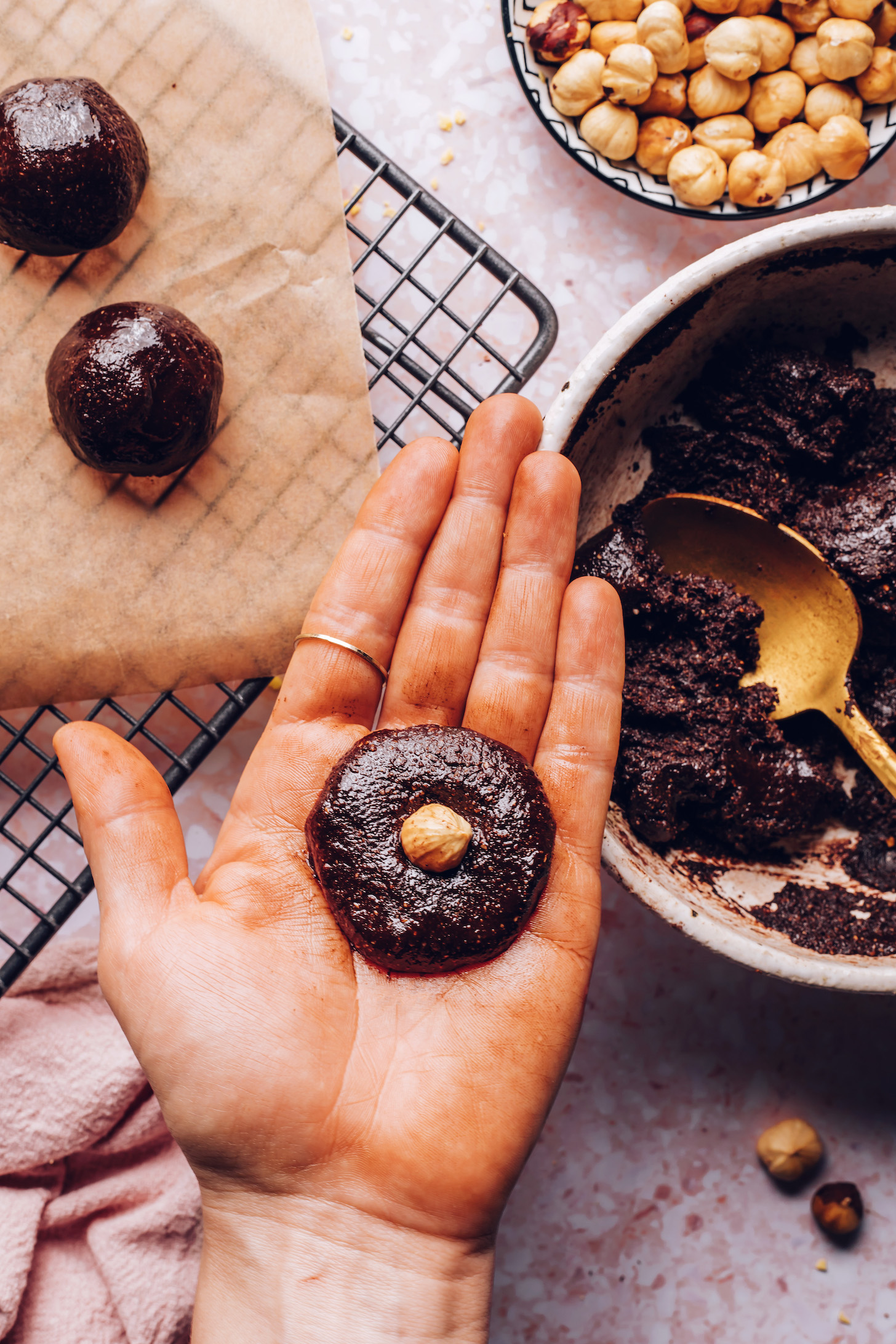 Holding a fudgy chocolate mixture with a hazelnut in the center