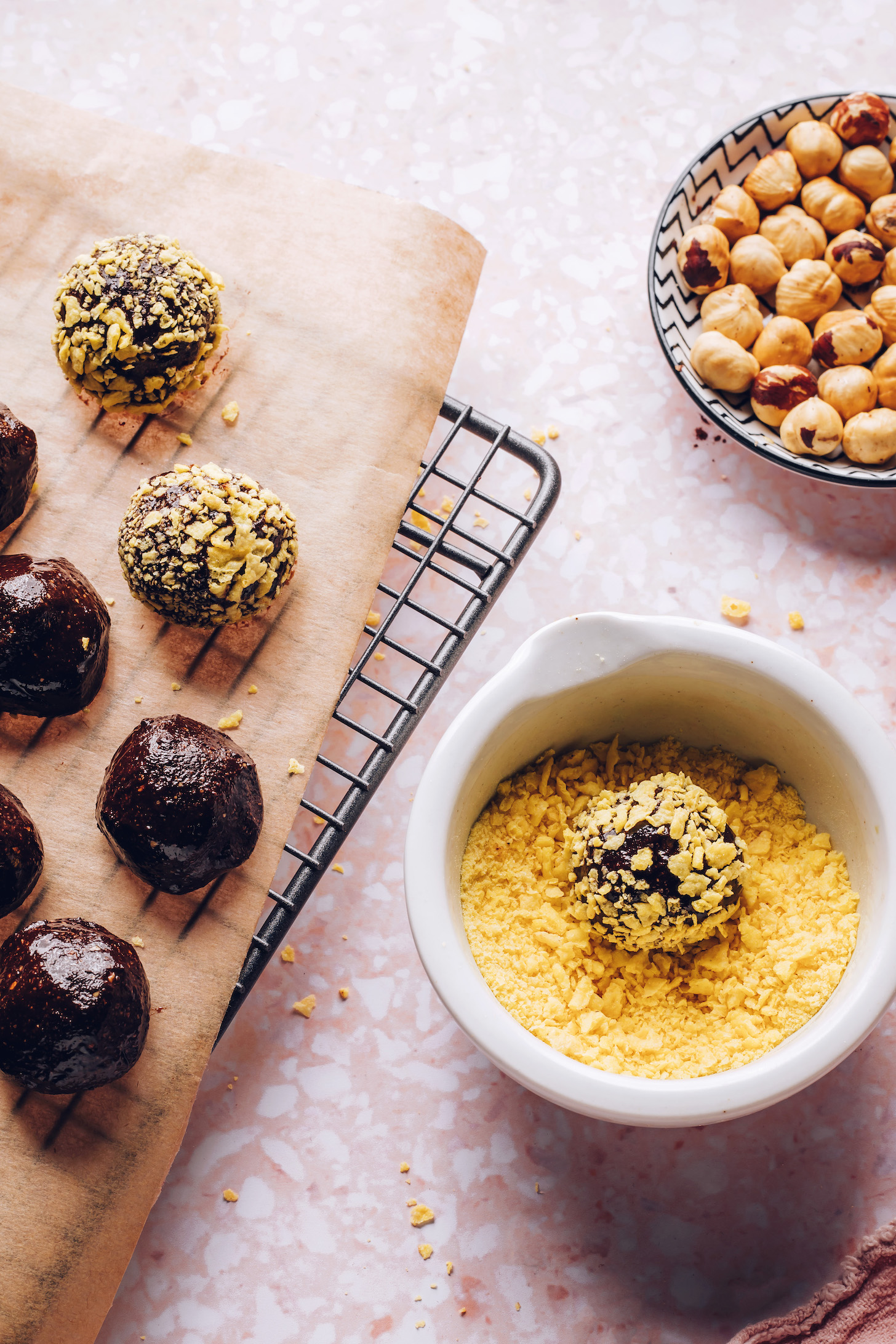 Rolling DIY Ferrero Rocher Chocolates in crumbled cornflakes for the crispy wafer layer
