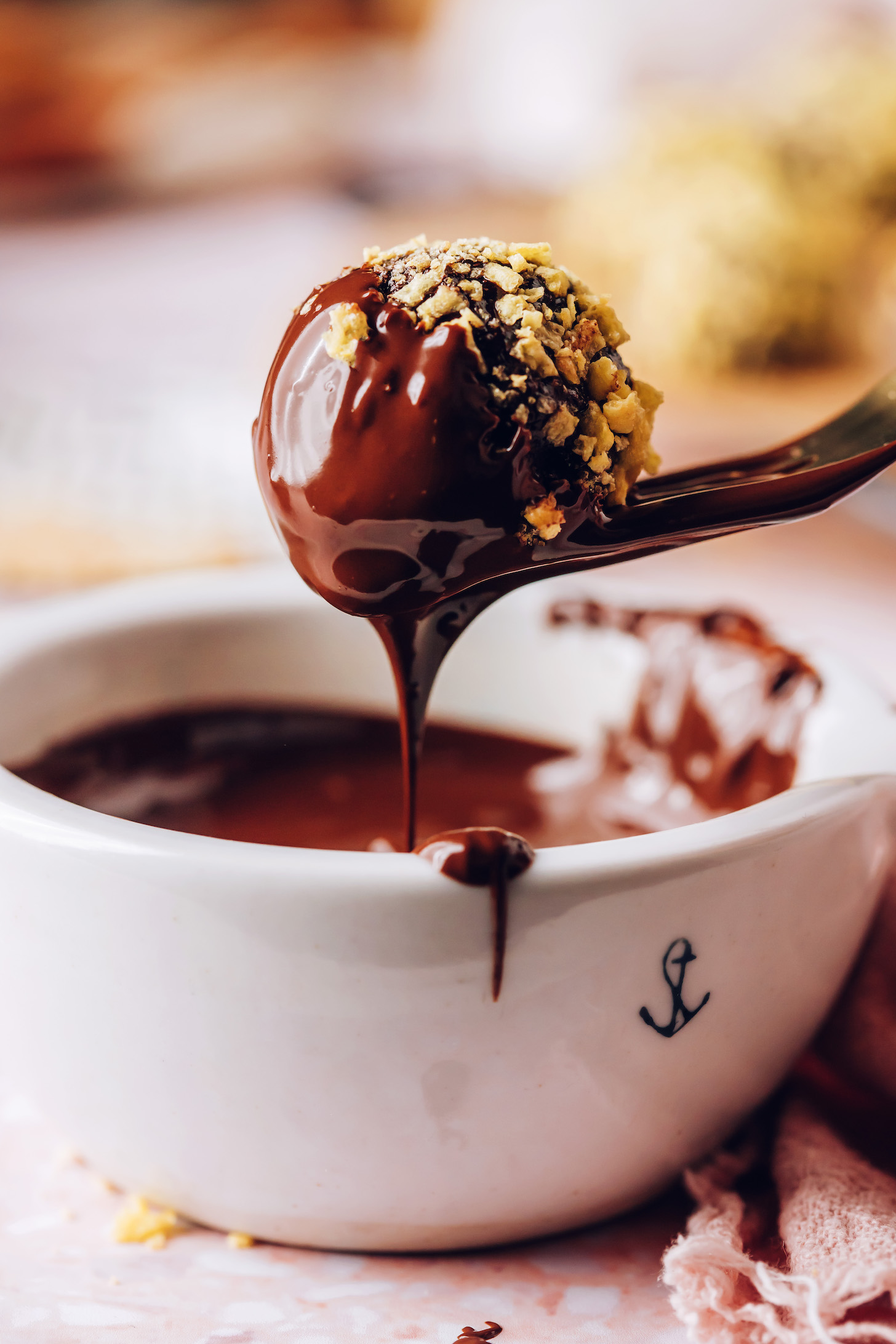 Fork holding a cornflake-crusted chocolate truffle dipped in melted chocolate