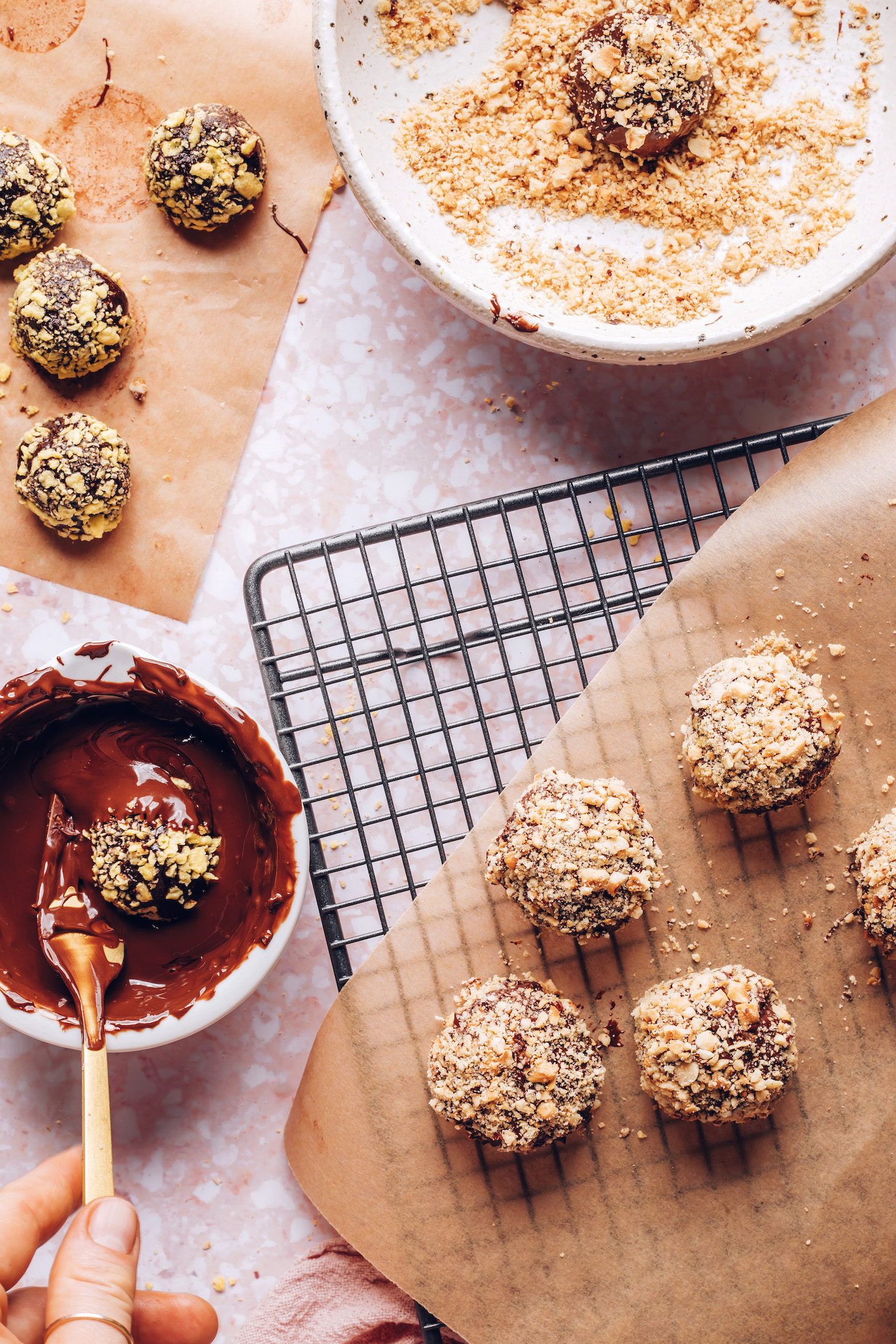 Dipping a chocolate truffle in melted chocolate for the outer layer of a homemade Ferrero Rocher