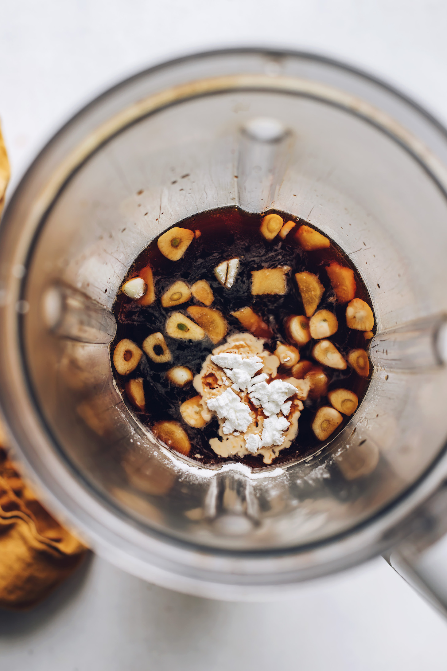 Corn starch, garlic, and other ingredients for making gluten-free teriyaki sauce in a blender