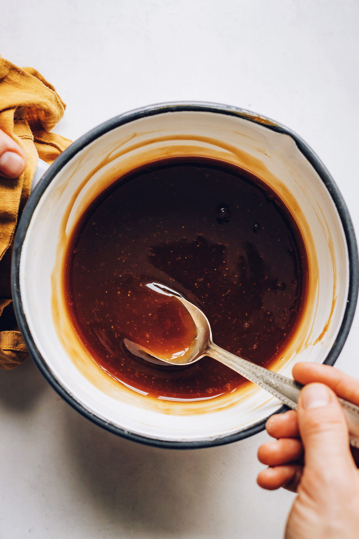Stirring homemade teriyaki sauce in a saucepan