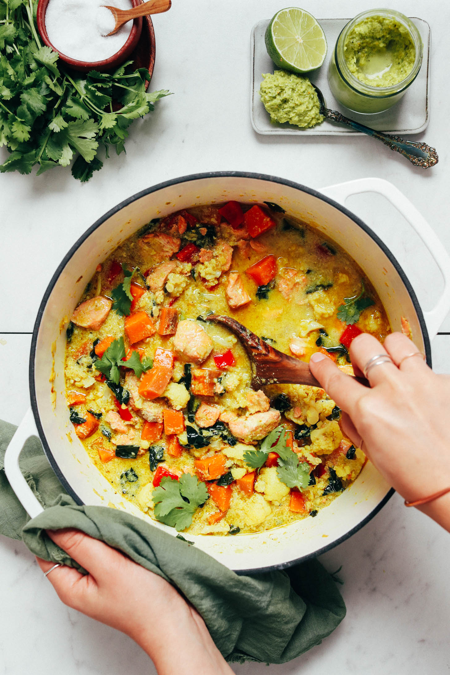 Stirring a pot of salmon green curry