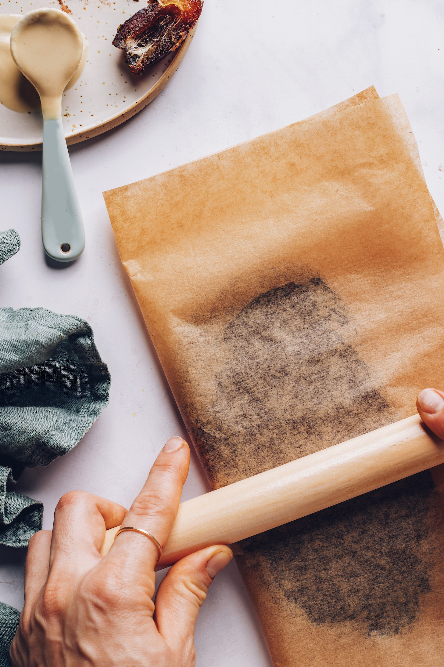Using a rolling pin to roll out the chocolate in parchment paper