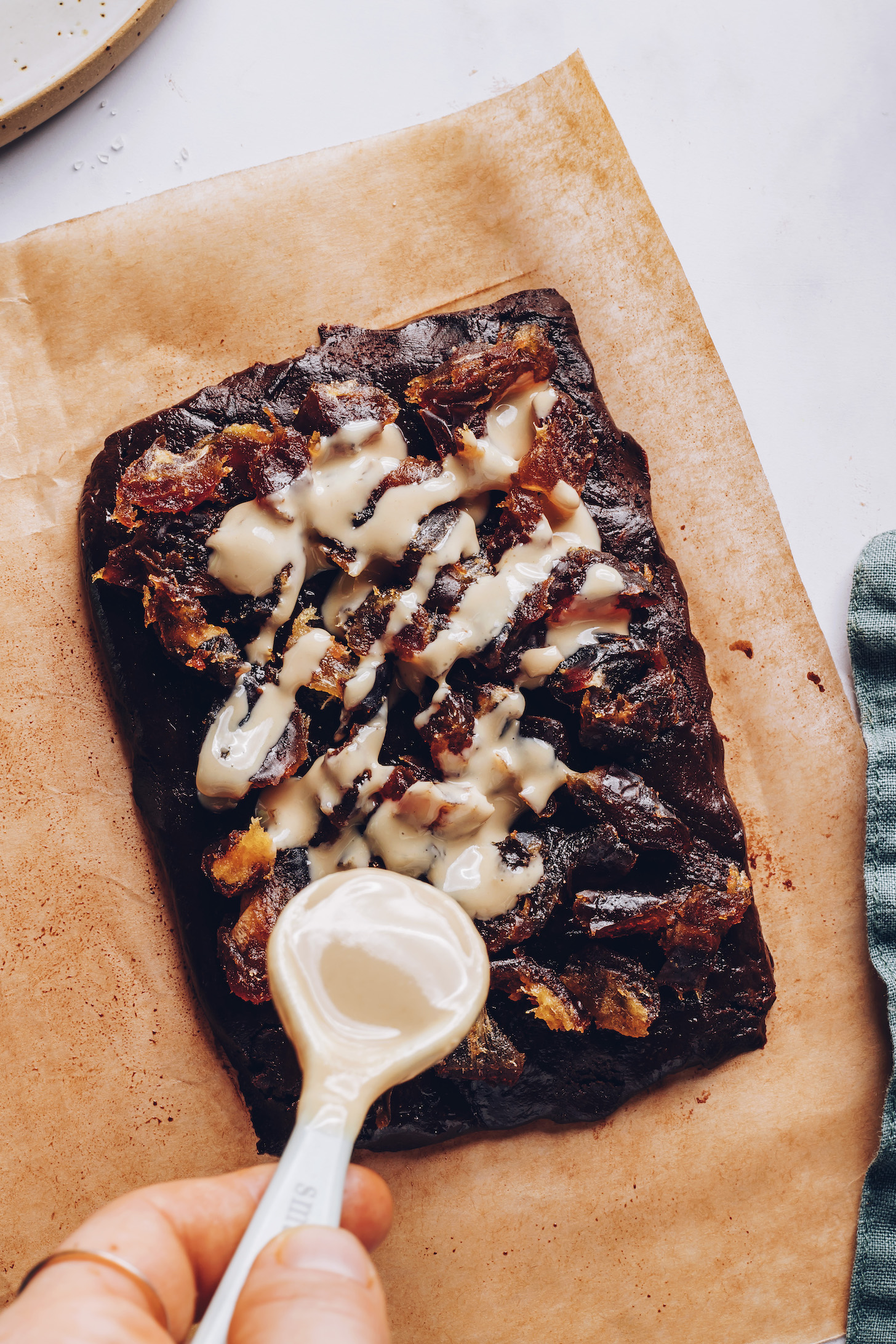 Drizzling tahini over date chocolate bars