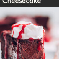 Slice of vegan and gluten-free easy baked chocolate cheesecake with non-dairy whipped cream and raspberry drizzle on top