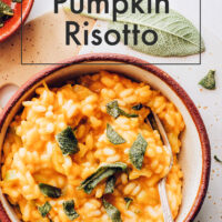 Bowl of pumpkin risotto topped with sage