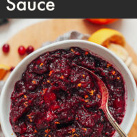 Bowl of easy 3-ingredient orange cranberry sauce with a spoon in it