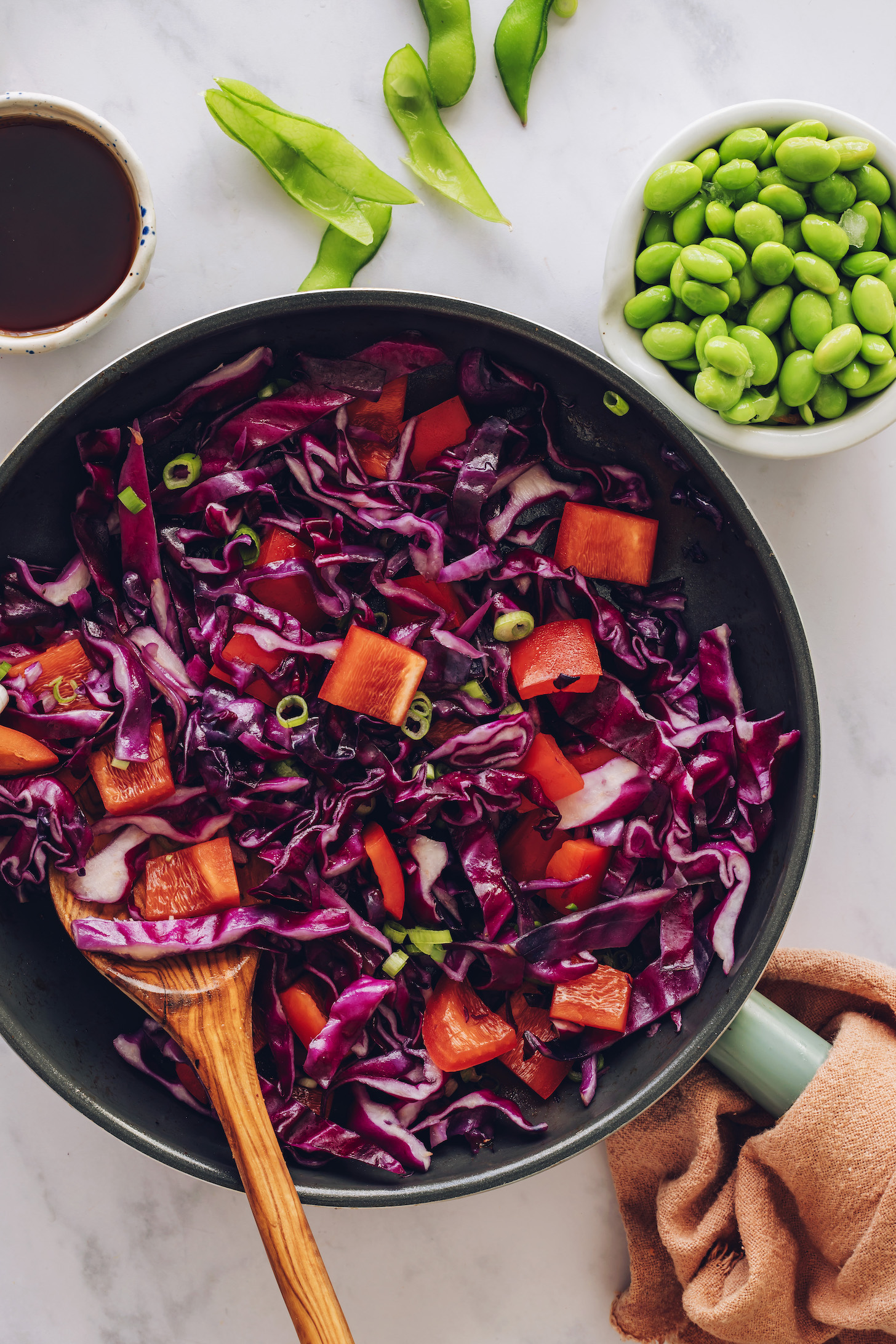 Sautéing red bell pepper, cabbage, and green onion