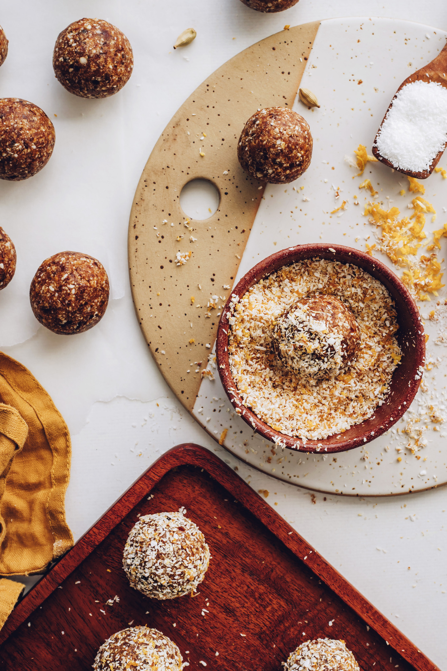 Energy bites scattered around a platter and on a tray