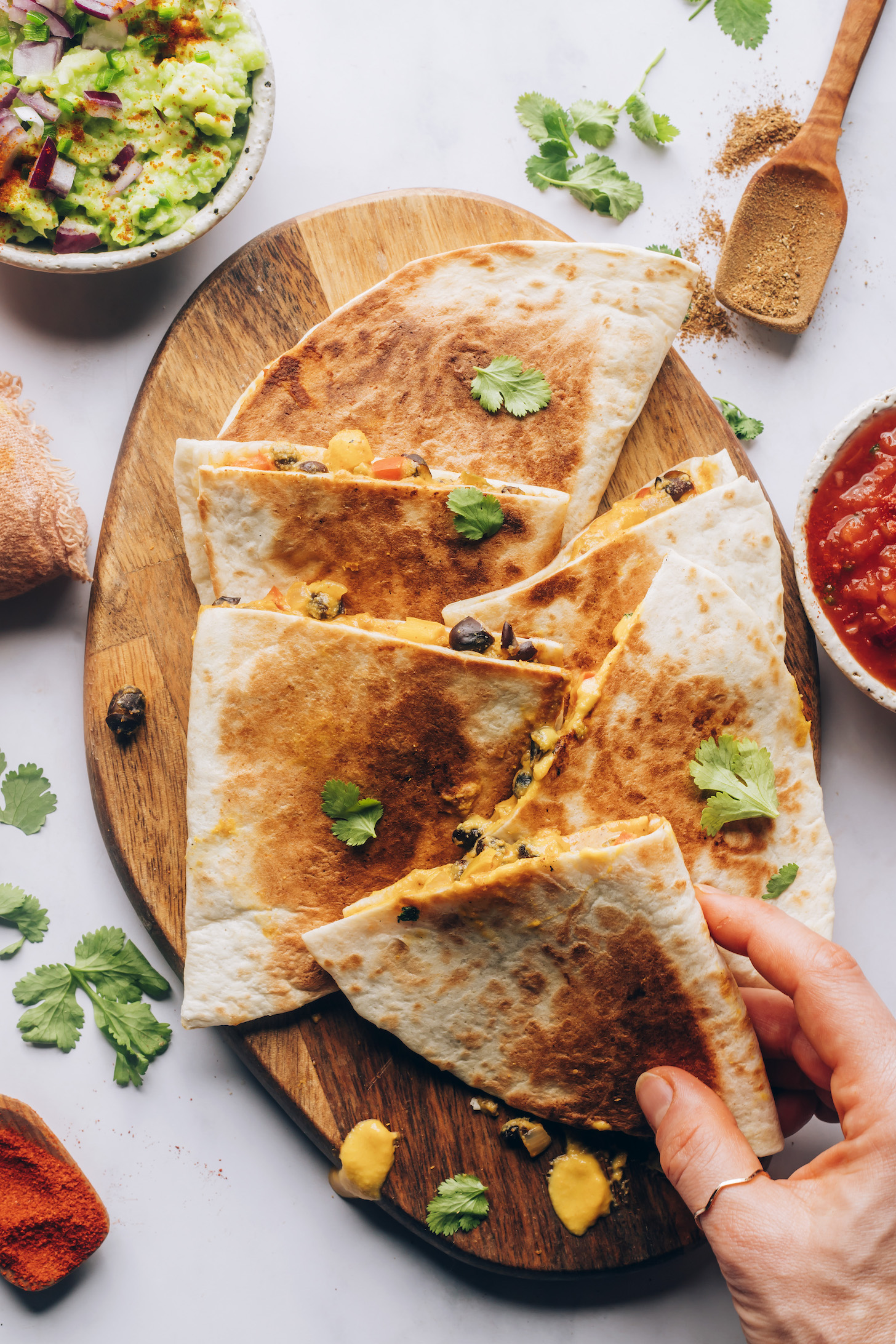 Vegan quesadillas on a wood cutting board
