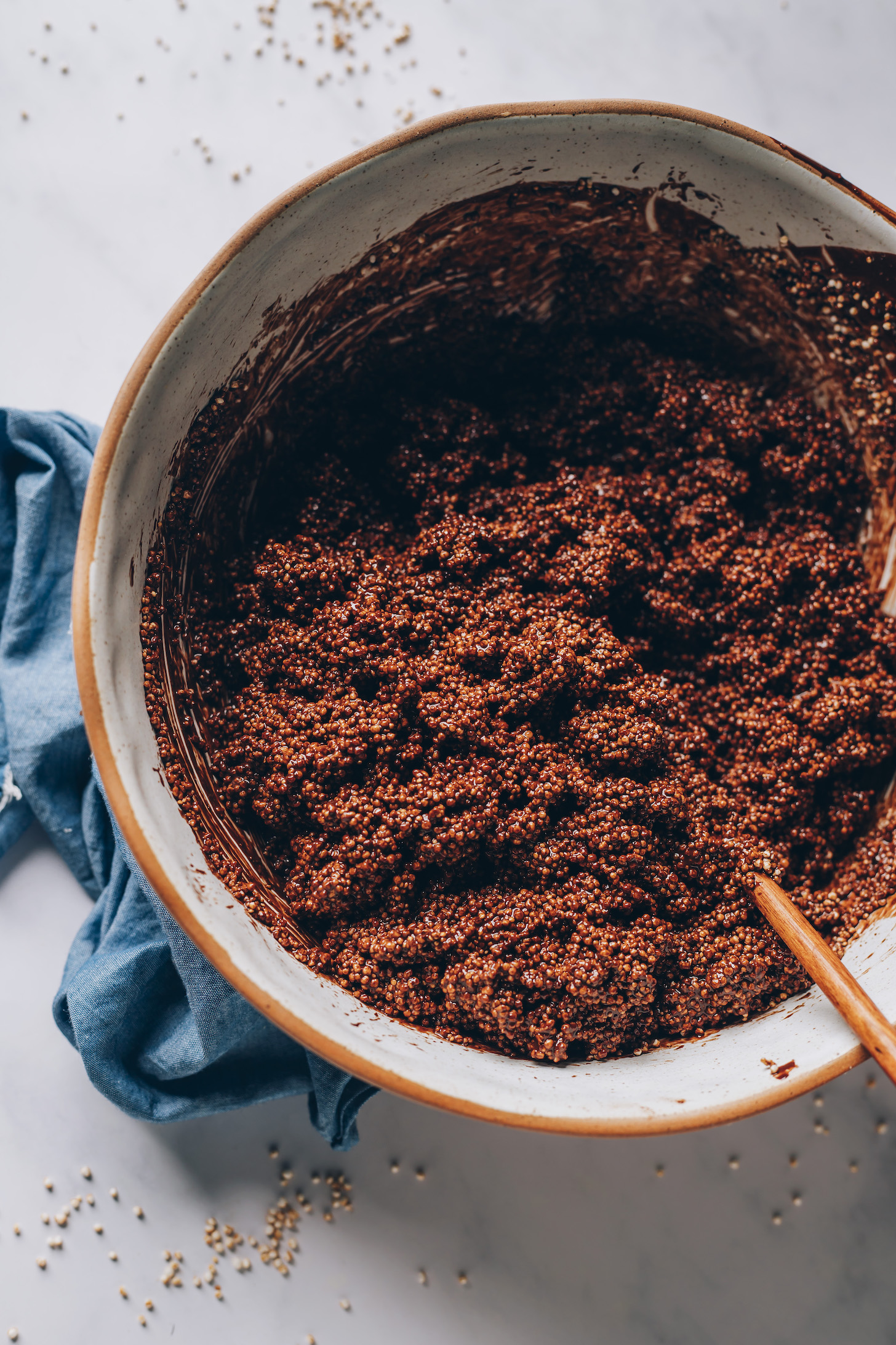 Wooden spoon in a bowl of chocolate amaranth mixture