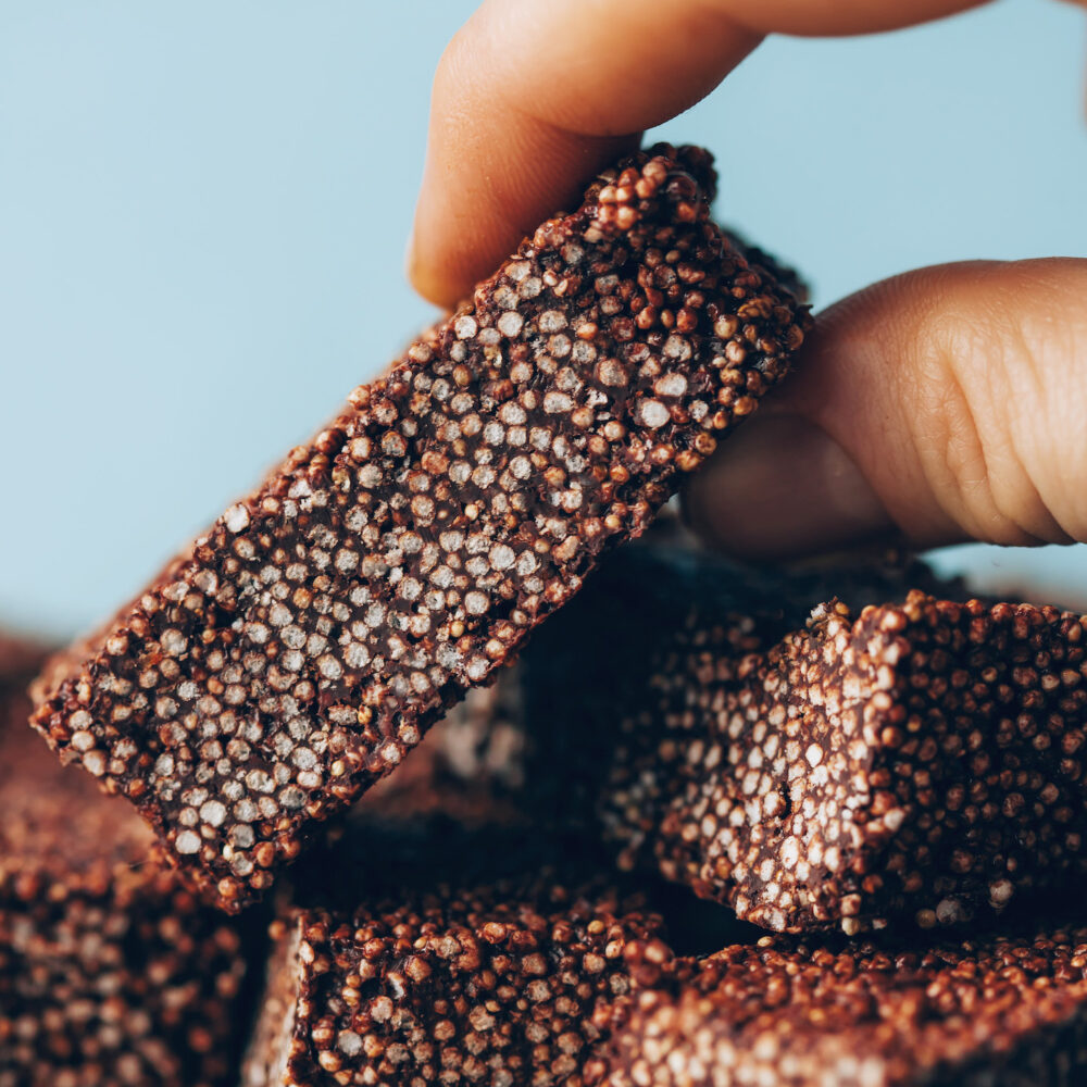 Picking up a chocolate amaranth bar from a stack
