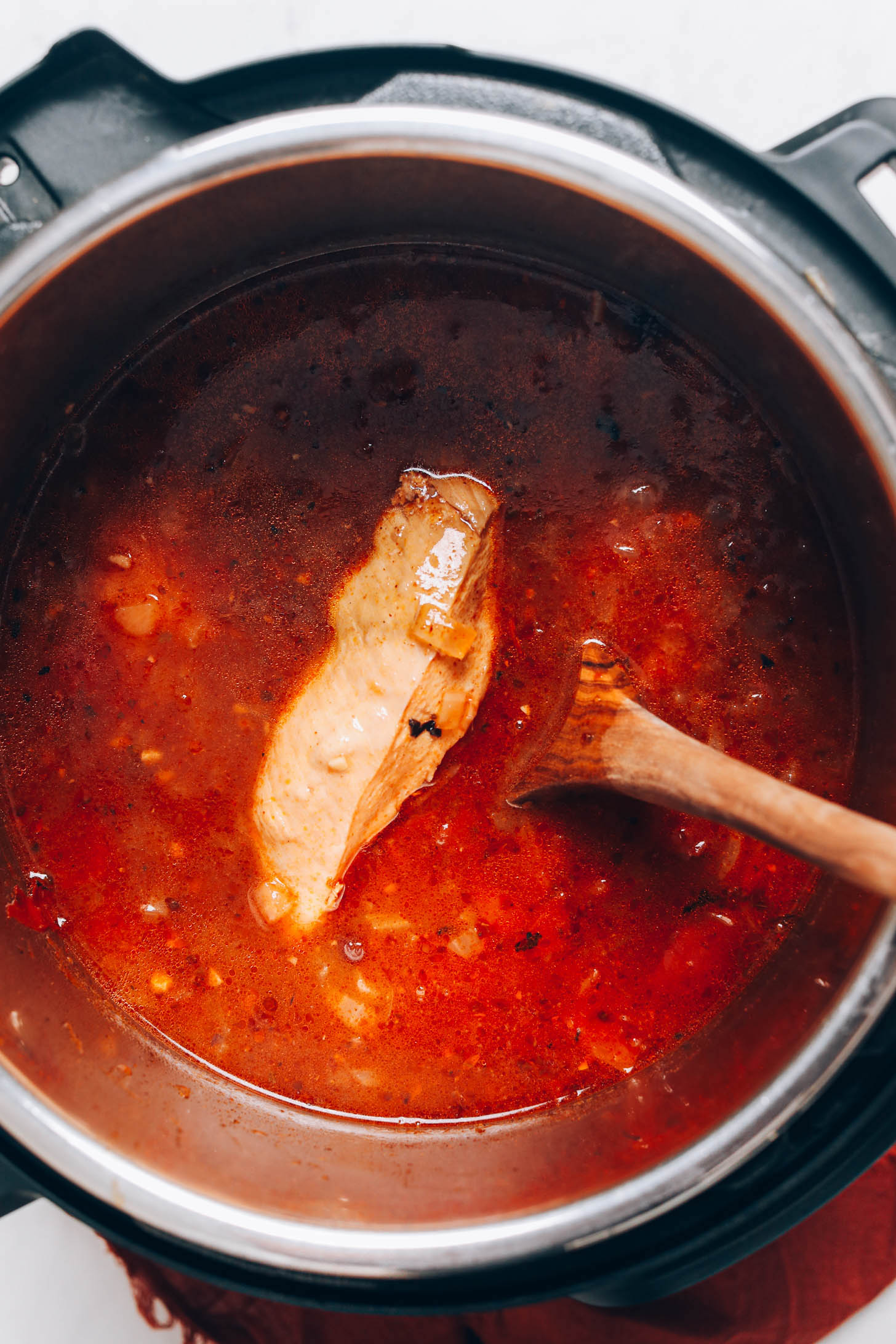 Picking up a cooked chicken breast from the Instant Pot