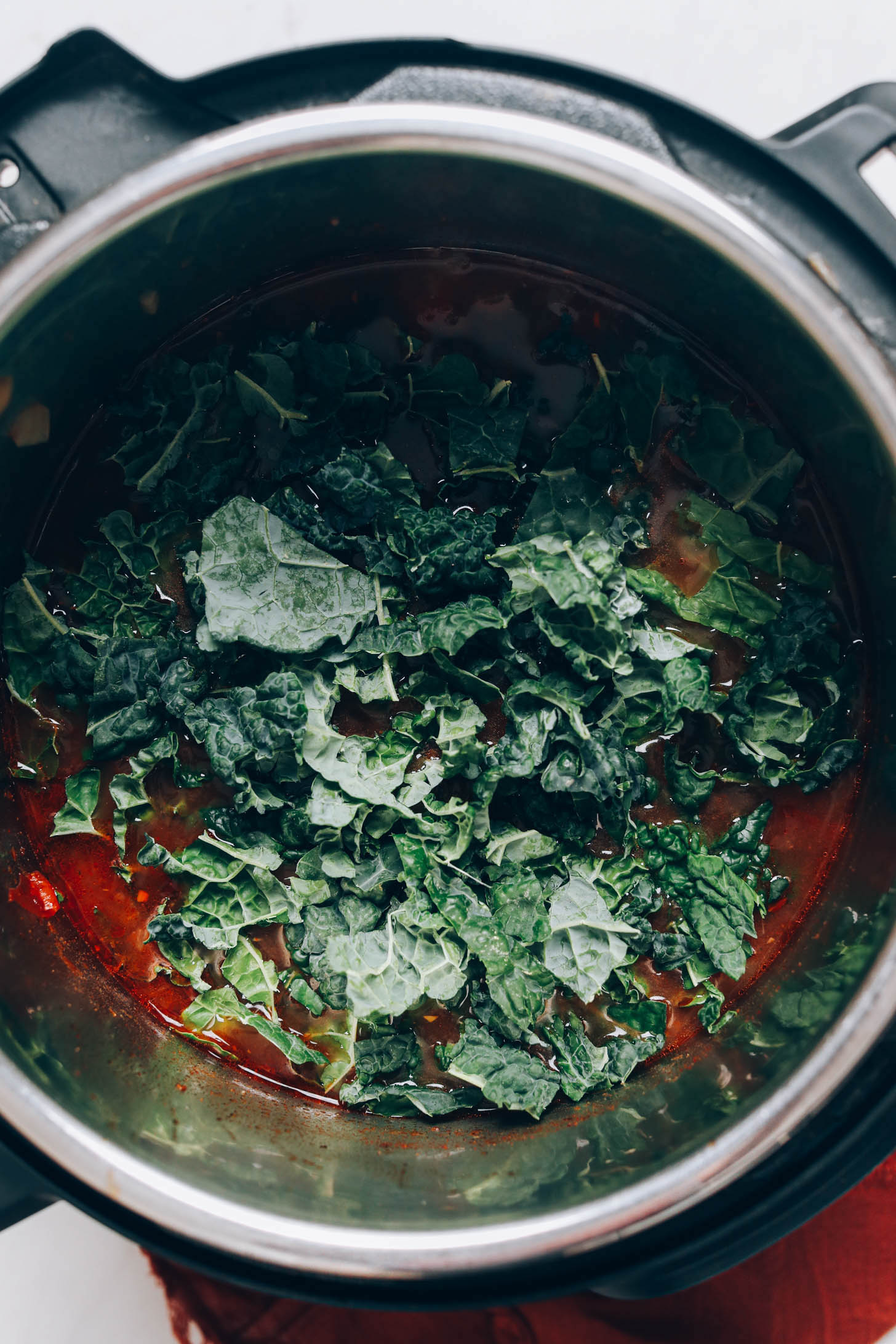 Chopped kale on top of chicken tortilla soup