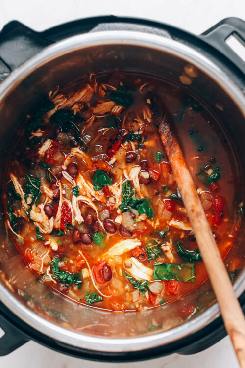 Wooden spoon in a pot of chicken tortilla soup