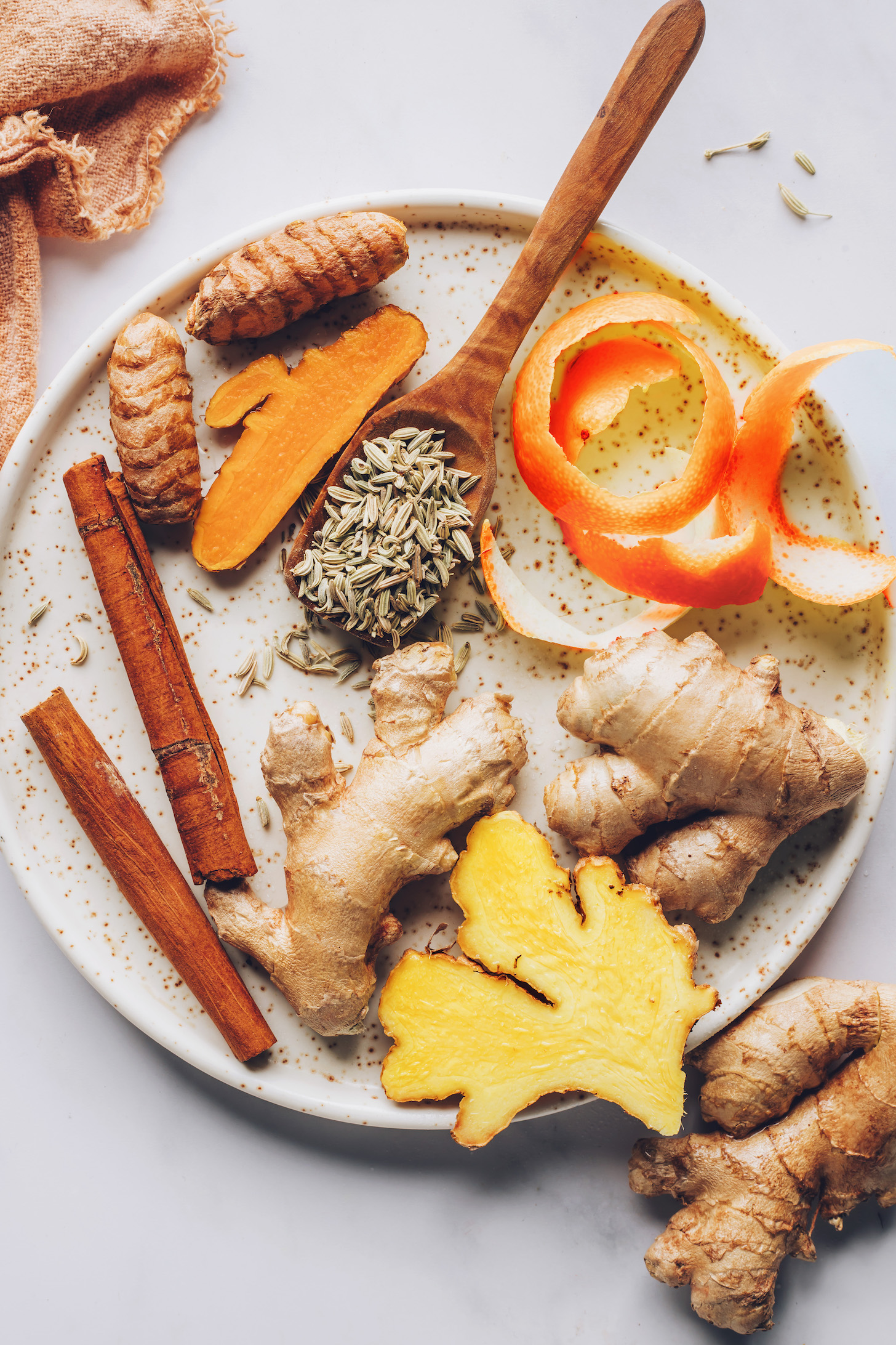 Fresh ginger, orange peel, fennel seeds, fresh turmeric, and cinnamon sticks