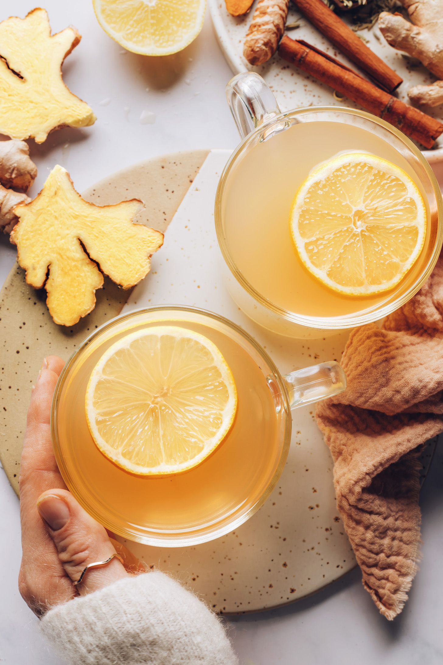 Mugs of fresh ginger tea with lemon slices