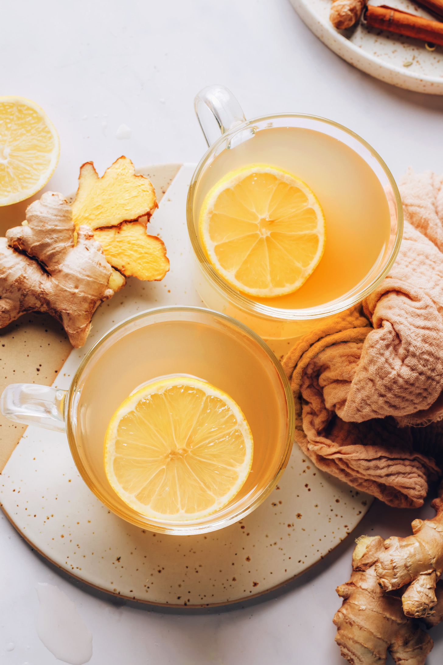 Lemon slices in mugs of homemade ginger tea