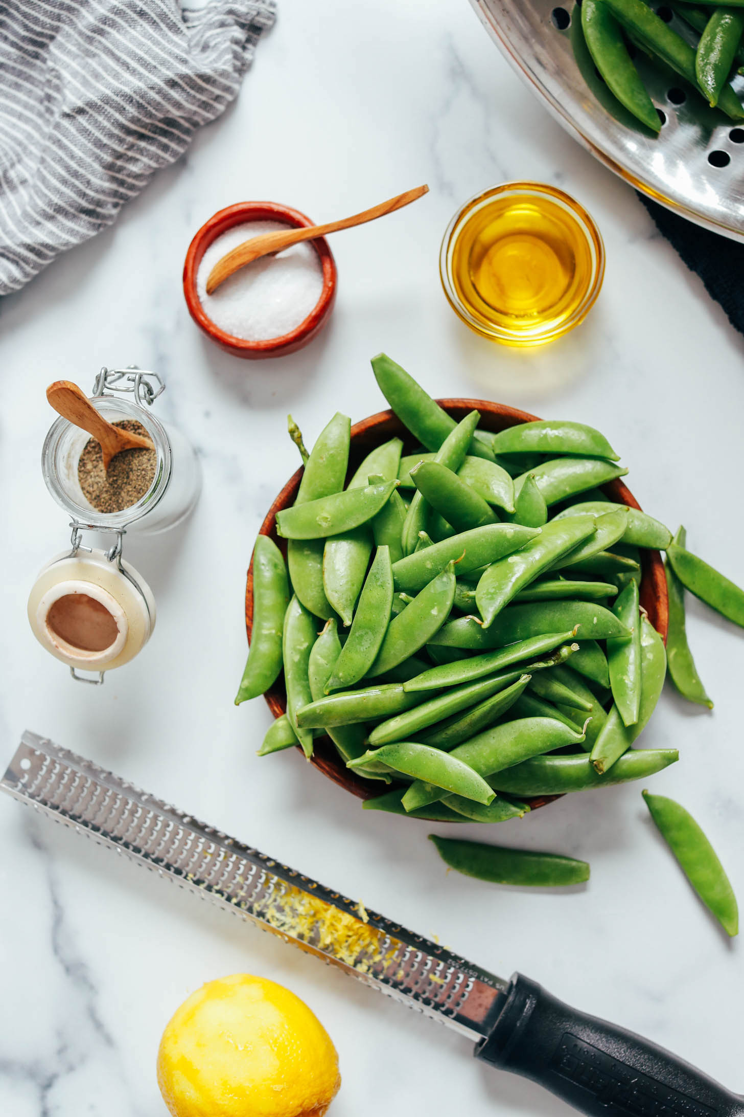 Olive oil, salt, pepper, lemon zest, and snap peas