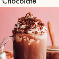 Cup of dairy-free instant hot chocolate with non-dairy whipped cream and cocoa powder on top