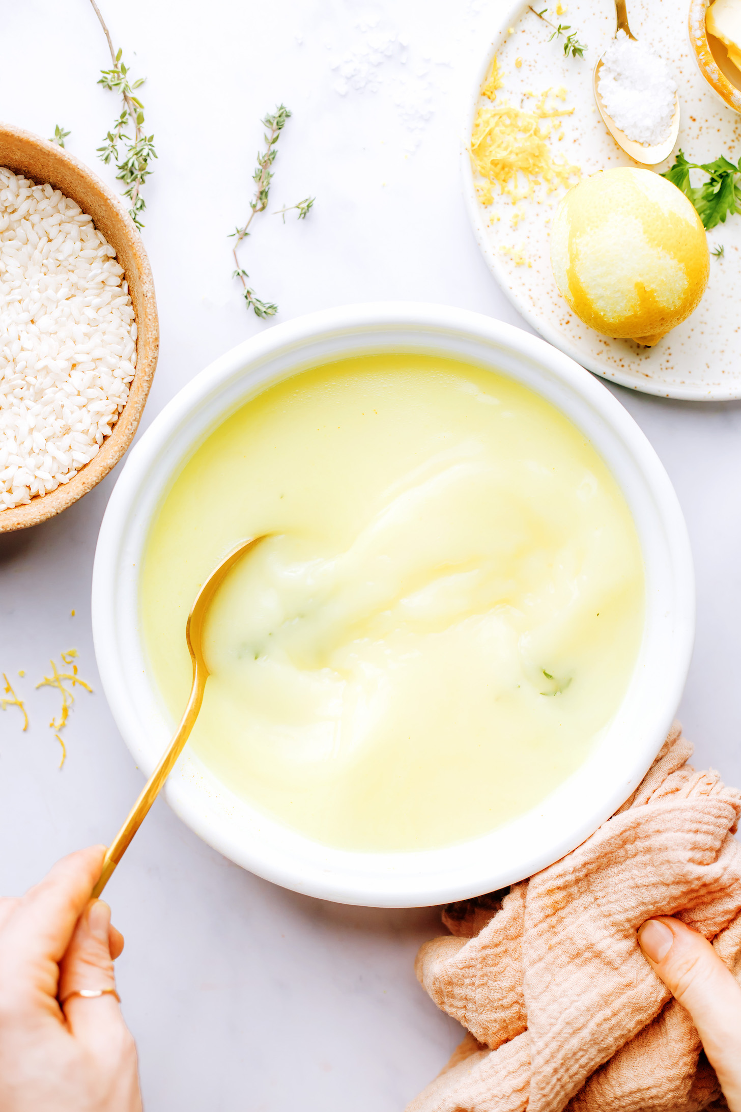 Creamy broth for risotto made of water, coconut milk, turmeric and fresh herbs
